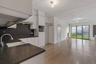 Dit zeer net gelijkvloers appartement is ideaal als startersappartement of als investeringsappartement!<br /><br />Via de zeer nette inkomhal heeft u toegang tot het appartement met open keuken. De keuken is volledig ingericht met vaatwas, kookplaat, koelkast met vriesvak en combi-oven. <br />De woonkamer heeft een mooi zicht op de tuin. De tuin is omheind en voorzien van een poortje zodat u ook via de achterkant van het terrein naar het tuintje kan. <br /><br />Badkamer met bad, toilet en wastafel en aansluitingen voor wasmachine en droogkast.<br />Ruime slaapkamer. <br /><br />Momenteel is er in de woonkamer nog een extra bergruimte/slaapkamer gemaakt, deze kan eventueel terug verwijderd worden om de woonkamer te vergroten. <br />In de gemeenschappelijke inkomhal beschikt het appartement over een praktische individuele afsluitbare berging. <br /><br />Achtergelegen garagebox verplicht aan te kopen aan 20.000euro. Tevens een gemeenschappelijke overdekte fietsenberging. <br /><br />Buitengewone kenmerken:<br />* gemeenschappelijk dak werd volledig gerenoveerd met isolatie van 16cm<br />* vaatwas is vernieuwd in 2021 en de kookplaat in 2022, renovatie badkamer 2022<br />* recent vernieuwde verwarmingsketel