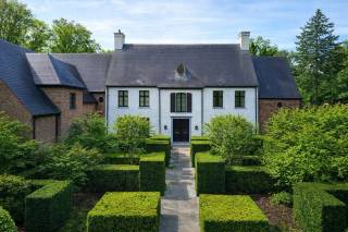 Op absolute toplocatie gelegen prachtige Herenwoning met ca. 5566 vierkante meter, met o.a. een discreet geïntegreerde service-unit met eigen toegang en interne ontsluiting, verwarmd zwembad en volwassen tuin.<br /><br />Indeling gelijkvloers; ruime entree centrale aslijn, vestiaire en gastentoilet, ruim salon met eiken planken en knappe gashaard, aanpalend tuinkamer met bar en zitruimte, aparte gezellige tv kamer voorzien van ingemaakte kasten en home theater, riante leef-keuken met Aga-fornuis, eetkamer en zitgedeelte, toegang naar ontspanningsruimte met hamam, kleedruimte en toilet wat mooi aansluit bij het zwembad met ingebouwde whirlpool in de tuin, toegang naar unieke wijnkelder voorzien van koeling, voorraadkelder, technische ruimte en zwembadkelder. Garage voor drie wagens met automatische poorten en handige fietsenberging met extra brede deur. Tweede entree met trap naar de service-unit (conciërge) welke voorzien van een ruime living met open keuken, slaapkamer met kasten en badkamer.<br /><br />Indeling verdieping;<br />Overloop waarop uitkomen, een supermooi oudersuite met slaapgedeelte, dressing voor haar en dressing voor hem en een luxe badkamer, tweede ruime slaapkamer met dressing, duplex en eigen badkamer, derde ruime slaapkamer met dressing en eigen badkamer, en een ontsluiting naar de service-unit (conciërge).<br />Indeling tweede verdieping; een vierde en vijfde ruime slaapkamer en badkamer, berging, en apart toilet.<br />Opmerkingen: bouwjaar 1996, upgrade 2014.