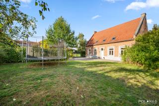 Charming country house featuring four rooms, playroom attic, cellar, carport with EV charging station, spacious terrace, and a lovely garden with a garden shed, situated on a plot of 12a 01ca in the heart of Binkom.<br /><br />Anyone dreaming of a historic farmhouse from 1785 where authentic character meets contemporary comfort will find their dream home here in the heart of Binkom. This fully renovated country house combines excellent energy efficiency with a 12a 01ca plot and a delightful, private outdoor space.<br /><br />The well-maintained entrance hall with guest toilet and cloakroom immediately invites you to explore further. You enter the spacious L-shaped living room, which is flooded with natural light and offers a tranquil view of the garden. Adjoining is the fully equipped kitchen with all conveniences, handily flanked by a large, practical storage and laundry room. Furthermore, the ground floor features a nicely decorated relaxation area that is perfectly suited as an office or fourth bedroom.<br /><br />Via the staircase, you reach the spacious, central night hall on the first floor, offering additional possibilities for an open workspace. Here you will find three comfortable bedrooms and a modern bathroom equipped with both a bathtub and a walk-in shower. The top floor houses a brilliantly finished playroom attic with a separate storage room, ideal for growing children. In addition, the property features an authentic vaulted cellar.<br /><br />A spacious 52m² terrace extends around the house, from where you can enjoy the lovely, well-kept garden in complete privacy. In the front garden, the large renovated bakehouse catches the eye, serving excellently as a workshop, practice room, or play area. The picture is complete thanks to the carport with an EV charging station and various parking spaces on private property.<br /><br />This property was completely renovated around 2012 and therefore offers plenty of modern comfort. This results in an energy-efficient home (label B - 158 kWh/m²/year); the electrical installation is compliant and the house is asbestos-safe.<br />Oil-fired central heating. Rainwater cistern and groundwater well present, as well as a water softener.<br />A modern home in an authentic, historic building. In absolute top condition and immediately ready to move into.<br /><br />Located in the centre of Binkom with a very easy connection to the centre of Lubbeek (3 km): shops, supermarket, school, childcare, restaurants, etc. are all easily accessible. Moreover, "Het Gouden Kruispunt" is approximately 5 minutes away.<br />There is also an excellent traffic connection to Leuven, Tienen, Aarschot, and Diest.<br />The E40 motorway access (Boutersem) or the approach to Aarschot is 15 minutes away.