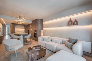 Ideally located in the vibrant centre of Knokke, just a short stroll from the seafront, sandy beach and exclusive boutiques, this beautifully renovated apartment perfectly combines elegance, comfort and an exceptional location.
Upon entering, the welcoming entrance hall features a cloakroom, guest toilet and a practical laundry room. The bright living and dining area enjoys pleasant partial sea views and has been finished with bespoke built-in cabinetry and a stylish bar unit. The open-plan travertine kitchen is fully equipped with premium Miele appliances, including a wine cooler. The apartment offers three comfortable bedrooms. The spacious master bedroom features built-in wardrobes and a luxurious en-suite bathroom with a shower, washbasin and toilet. The second bedroom also benefits from built-in wardrobes and is served by a separate shower room. The third bedroom is currently fitted with bunk beds and a desk but can easily accommodate a double bed if desired. Each bedroom opens directly onto the sunny rear terrace of approximately 36 m², providing a wonderful outdoor space to relax in complete privacy. All bedrooms are fitted with electric shutters. Residents also benefit from the presence of a concierge and a communal bicycle storage room.
Looking for a move-in-ready apartment in one of Knokke's most sought-after locations? Contact Alex Dewulf for more information or to arrange a private viewing.