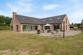 Villa moderne avec une surface habitable de 524m² sur un terrain d'environ 1ha avec dépendance d'environ 400m². La villa a été construite en 1980, mais récemment entièrement rénovée et rénovée! Bon score EPC de 49 kWh/m²/an (étiquette A). Elle comprend un salon spacieux, une cuisine ouverte spacieuse (cuisine à réaliser), 3 à 4 chambres à coucher, 1 salle de bain (possibilité de réaliser une 2ème salle de bain ainsi qu'une salle de douche supplémentaire, l'espace et les raccordements sont déjà prévus), 2 espaces bureau au rez-de-chaussée, une buanderie et suffisamment d'espace de rangement dans la maison. Sur le terrain, une dépendance d'environ 400m².<br /><br />En entrant dans le grand hall d'entrée avec toilettes pour invités, vous ressentirez immédiatement l'espace et la luminosité. Le salon dispose d'une belle salle à manger et d'un coin salon confortable. La cuisine ouverte est adjacente et doit encore être aménagée. Vous pouvez y faire votre propre chose! Adjacent à la cuisine se trouvent 2 espaces de rangement pratiques à utiliser comme garde-manger ou espace de stockage supplémentaire. Il y a également une cave d'environ 12m². Au rez-de-chaussée, 2 grands espaces bureau sont prévus mais peuvent également servir de chambre à coucher. À côté du hall d'entrée se trouve une buanderie spacieuse. Entrée arrière avec toilettes supplémentaires et espace séparé où vous pourriez éventuellement installer une douche.<br /><br />L'escalier en béton vous mène à l'étage. La chambre principale se trouve à l'arrière droit de la villa et bénéficie de placards encastrés supplémentaires et d'espace pour créer une salle de bains attenante. En outre, 2 chambres d'enfants très spacieuses et une salle de bain avec douche, baignoire, double lavabo et armoires de rangement.<br /><br />Le jardin est agréable grâce à son orientation sud et à sa vue dégagée. Sur le terrain se trouve une dépendance d'environ 400m².<br /><br />Caractéristiques exceptionnelles:<br />- Emplacement calme et rural avec une vue magnifique et situé au bout d'une impasse!<br />- Vide sanitaire sous la maison et cave d'environ 12m²<br />- Chauffage par le sol et refroidissement par pompe à chaleur disponible à la fois au rez-de-chaussée et au premier étage, chauffage et refroidissement par une unité de climatisation économe en énergie au premier étage.<br />- Bonne étiquette EPC A<br />- 2 citernes d'eau de pluie de 10 000 litres chacune ainsi qu'un puits de 200m de profondeur<br />- panneaux solaires de 12kVa<br />- enceintes acoustiques invisibles stealth acoustic intégrées, magnifiques pour écouter de la musique de cette manière dans la maison!