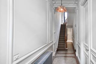 <p>Sommige huizen trekken je aandacht. Andere doen je even vertragen...<br />Deze prachtige woning op de grens van het Groen Kwartier en Oud-Berchem is er zo eentje.</p>
<p>De gevel alleen al is er eentje om even bij stil te staan. Beschermd erfgoed, rijk aan details en met die typische neoclassicistische en eclectische flair die je vandaag nog zelden ziet. Zo’n gevel die je hart spontaan een sprongetje laat maken… en terecht.</p>
<p>Binnen wordt dat gevoel alleen maar versterkt.<br />De inkomhal is ronduit indrukwekkend: verfijnde moulures, een prachtige marmeren mozaïekvloer en een elegantie die je meteen meeneemt. Achteraan vind je een praktische vestiaire met gastentoilet, en ingemaakte kasten waarin wasmachine en droogkast discreet hun plek kregen. Alles doordacht en mooi weggewerkt.</p>
<p>En ook de leefruimte voelt meteen juist.<br />Vooraan een leuke zithoek. Aansluitend een eetkamer waar diners al snel uitlopen in lange avonden. En dan de knappe keuken… strak, volledig uitgerust en met een toog die zich perfect leent voor elk moment van de dag.</p>
<p>Halverwege de trap wacht een verrassend extraatje.<br />Een terras van maar liefst 20 m², zuid-oost georiënteerd en werkelijk een verborgen parel. Hier begint je dag met zon en eindigt ze met rust. Van een rustige koffie tot een levendige BBQ met vrienden, dit is zo’n plek die al snel onmisbaar wordt.</p>
<p>Op de eerste verdieping bevindt zich een royale kamer aan de voorzijde, vandaag ingericht als een bijzonder gezellige tv-ruimte. Daarnaast de badkamer: stijlvol, ruim en helemaal op maat van jouw ritme. Kies voor een ontspannen moment in bad of een snelle, verkwikkende douche. Dubbele lavabo, tweede toilet… check.</p>
<p>De tweede verdieping biedt nog twee mooie slaapkamers, elk met hun eigen sfeer en mogelijkheden.</p>
<p>En dan het technische plaatje, minstens even belangrijk:<br />De woning werd in 2018 en 2021 grondig en smaakvol gerenoveerd, is perfect onderhouden, beschikt over een mooi EPC en conforme elektriciteit.<br />Hier koop je charme en komt de gemoedsrust erbij!</p>
<p>De ligging maakt het verhaal compleet.<br />Op wandelafstand van het station, met de fiets sta je zo in het centrum en rondom je: een heerlijke buurt.<br />Van een etentje bij Café Service tot een glas wijn bij Django, frietjes bij Café Congé of een koffietje bij Caffenation of Polly… hier woon je midden in één van de leukste stukjes Antwerpen.<br /><br />Dit is echt een huis waar je binnenkomt en... eigenlijk meteen wil blijven.<br />Benieuwd? Plan dan zeker een bezoekje in (en vergeet je slaapzak niet ;-) )!<br /><br /></p>
Troeven:<br />- Charmante woning met karakter<br />- Beschermde gevel <em>(onroerend erfgoed: burgerhuis in neoclassicistische &amp; eclectische stijl)</em><br />- Zeer gegeerde locatie<br />- Authentieke elementen<br />- Zonnig terras (niet vergund<span>)</span><br />- Smaakvolle renovatie<br />- Volledig uitgeruste, kwalitatieve keuken<br />- Ingemaakte kasten (incl. wasruimte)<br />- Droge kelder<br />- AREI conform<br />- CV op gas (condensatieketel)<br />- Dubbele beglazing<br />- Vraagprijs is richtprijs<br /><br />Wg, Gvkr, Gvv, Vg, Gmo, Geen overstromingsgevoelig gebied