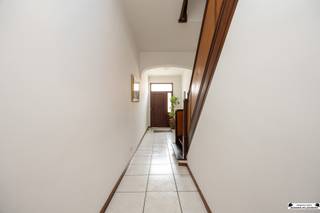 <p>Layout<br />On the ground floor, you are welcomed into a spacious entryway that provides access to the various living areas. The bright living room opens onto an open kitchen with basic amenities and offers a pleasant view of the garden. The home also features a spacious garage of approx. 31.5 m² with a ceiling height of about 3 meters and a manual sectional door. The fully fenced city garden enjoys a favorable southwest orientation, allowing you to enjoy the sun here all afternoon and evening.<br />The first floor comprises no fewer than four bedrooms and a bathroom. The first bedroom (approx. 13.5 m²) has direct access to the bathroom, which is equipped with a bathtub, sink, and toilet. Bedroom 2 is accessible via bedroom 1 and features authentic plank flooring with an area of approx. 15.5 m². In addition, there is bedroom 3 with plank flooring (approx. 15.5 m²) and bedroom 4, a smaller room of approx. 6 m².<br />The second floor has the same layout and again offers four rooms and a bathroom. As a result, the home has a total of up to 8 bedrooms and 2 bathrooms, creating exceptional possibilities for large families or those seeking extra space for hobbies, a home office, or guest rooms.</p><p>Details:<br />- EPC: Label F (renovation required)<br />- Energy Certificate: non-compliant <br />- Asbestos: pending<br />- Roof renovation required:<br />- Oil-fired heating: oil-fired boiler is in working order, oil tank has been rejected. </p>