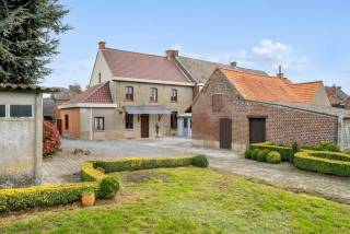 In het glooiende landschap van Zwalm, midden in de Vlaamse Ardennen, schuilt deze eigendom die zich onderscheidt door haar uitzonderlijke schaal, authentieke uitstraling en vooral haar veelbelovende potentieel. Dit is geen doorsnee renovatiewoning. Dit is een ruim en karaktervol eigendom van maar liefst 41 are 01 ca, met een indrukwekkende straatbreedte van circa 29,5 meter, gelegen in woongebied met landelijk karakter. De woning zelf ademt nog de sfeer en charme van vroeger. De solide structuur en verschillende authentieke elementen vormen een bijzonder mooie basis voor wie een woning met ziel wil renoveren en opnieuw tot leven wil brengen. Tegelijk zijn belangrijke investeringen reeds gebeurd: het dak werd vernieuwd, er is dubbele beglazing en de woning beschikt over een moderne keuken. Met een royale bewoonbare oppervlakte, vier slaapkamers op de eerste verdieping en daarboven nog een bijzonder ruime zolderverdieping met vaste trap, ontbreekt het hier allerminst aan mogelijkheden. De zolder is vandaag nog in te richten, maar kan uitgroeien tot een indrukwekkende extra leefruimte. Denk aan bijkomende slaapkamers, een bureau, hobbyruimte, speelruimte, atelier of zelfs een volledig eigen verdieping voor een toekomstige invulling.<br />De ruime stallingen en bijgebouwen bieden plaats voor voertuigen, opslag, materiaal, een atelier of andere projecten. Voor dierenliefhebbers is dit bovendien een bijzonder interessante omgeving, met alle ruimte om landelijk te wonen en te genieten van het buitenleven.<br /><br />Extra troef: uitzonderlijk bouwpotentieel<br />Een bijzonder sterke troef van deze eigendom is de ruime perceelstructuur en de uitzonderlijke straatbreedte van circa 29,50 meter.<br />Het eigendom omvat ruim 41are grond, waarvan een gedeelte naast de bestaande woning interessante mogelijkheden biedt voor een toekomstige bijkomende woonontwikkeling. Dit deel is momenteel niet afzonderlijk als bouwgrond verkaveld, maar de ligging en ruimtelijke context bieden perspectief. Voor een mogelijke bebouwing kan een ontwerpend onderzoek worden voorgelegd aan de gemeente Zwalm. Daarbij wordt bekeken hoe het plan van de architect kan worden ingepast in de bestaande omgeving. Dit betekent dat het perceel naast de woning een enorme meerwaarde heeft, met de waarde van bouwgrond met tal van mogelijkheden.<br /><br />De tweede foto is AI-bewerkt en geeft een beeld van hoe het landhuis op de binnenkoer er na verbouwing kan uitzien, de andere foto's zijn onbewerkt.<br />Neem contact op met Karin voor meer info: 0468/12 68 62 - karin@albert.immo