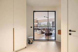 Sublimely finished ground floor design apartment, fully developed and realized by Huis Creemers, located in the historic heart of Tongeren.<br /><br />Sale under registration fees. No VAT!<br /><br />The apartment is part of the enclosed Residence 'Ilex', surrounded by a beautifully landscaped, mature garden. You live within walking distance of the center of Tongeren, with all amenities within reach.<br /><br />This recent apartment (built in 2020) offers a generous living area of 165 m² and has a beautiful southwest-facing terrace of 32 m². The interior concept is consistently carried through in every space, with a refined harmony between walnut wood, lacquer, and natural stone.<br /><br />The light-filled living space is equipped with custom-made cabinets, discreet integrated techniques, and a cozy gas fireplace, creating a sleek yet warm overall look.<br /><br />Central in the apartment is a generous kitchen island in quartzite natural stone. The kitchen is equipped with high-quality appliances, including a BORA hob, Siemens oven with steam function, Quooker tap, Liebherr fridge with ice cube function, and a built-in wine climate cabinet.<br /><br />The spacious bathroom combines aesthetics and functionality and is finished with custom-made Corian, a Whirlpool bath, walk-in shower, and high-quality Japanese toilet installation.<br /><br />Furthermore, the apartment has two bedrooms, one of which is currently furnished as an office or guest room. The master bedroom includes a stylish integrated built-in dressing room. A practical laundry room/storage room is discreetly integrated into the overall concept.<br /><br />On a technical level, this apartment is fully equipped for the future with an advanced home automation system, alarm system, and camera surveillance. With an energy performance level of E45 (77 kWh/m²·year) and energy label A, the property combines luxurious living comfort with excellent energy efficiency.<br /><br />The whole is completed by an additional parking space within the secure residence. For an additional fee, a very spacious private garage box can be purchased. An exceptional living opportunity for those who want to combine design, comfort, and tranquility in a prime location.