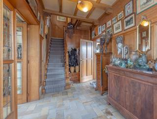 <p>Solid home with a stunning view.</p>
<p>This charming property is ideally located in an easily accessible yet rural setting in Itterbeek, Dilbeek.</p>
<p>The spacious entrance hall leads to the bright living room at the front of the house. Large windows flood the space with natural light, while the authentic open fireplace adds a warm and cosy atmosphere. At the rear, the spacious and fully equipped kitchen offers a magnificent view of the surroundings. Also on the ground floor, a generous bathroom with shower and vanity unit is available. The separate toilet is accessible from the enclosed terrace, which leads directly to the large garden (+/ 13 ares). On the first floor, three spacious bedrooms and a practical storage room are available, with ample built-in wardrobes throughout. A hatch provides access to an additional storage attic.</p>
<p>A major highlight of this home is the exceptionally large garage of approximately 65 m², fitted with an automatic door and adjoining cellar space, offering endless possibilities for storage, hobbies or use as a workshop. The driveway easily accommodates multiple vehicles.</p>
<p>Over the years, several improvements have been made, including the installation of a recent gas boiler, high-performance double glazing and a fully compliant electrical installation.</p>
<p>The property is centrally located with excellent access to Brussels, while enjoying the tranquility and greenery of its surrounding area.</p>