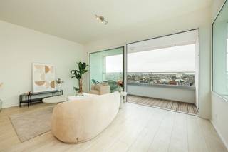 <p><span> </span></p><p><span>Want to live with Antwerp at your feet? You can here, on the eighth floor of a recently built building on Mediaplein. This bright corner apartment of approximately 86 m² features two bedrooms, radiant floor heating, ventilation, a lovely east-facing terrace, and above all: windows and views galore. The Stadspark, shops, and public transportation are nearby, and you can optionally purchase a parking space for € 30,000.</span></p><p><span>Light, space, and & views</span></p><p><span>Take the elevator to the eighth and top floor. The entryway features a videophone and provides access to the apartment’s various rooms.</span></p><p><span>The absolute highlight is the open living area of approximately 30 m². Thanks to its corner location and numerous large windows, daylight streams in from various directions, and you can enjoy sweeping views over Antwerp. There’s plenty of space for a living area and dining area, while a large sliding door connects the living space directly to the terrace. With minimal visibility from outside, you can relax here high above the city. It’s ideal for a morning coffee in the sun, with a panoramic view of Antwerp as an added bonus.</span></p><p><span>The open kitchen flows seamlessly into the living room and is practically equipped with an electric cooktop, range hood, combination oven, dishwasher, refrigerator with freezer compartment, and a double stainless-steel sink. Next to the living area, there is a separate storage room of approximately 2.5 m² containing the utility systems and hookups for a washing machine and dryer.</span></p><p><span> </span></p><p><span>Two bedrooms & e terrace with a view</span></p><p><span>Through the night hallway, you’ll reach the two bedrooms, measuring approximately 10 m² and approximately 9.5 m², respectively. Both face south, feature laminate flooring, and once again offer a beautiful view of Antwerp. The second room is ideal as a children’s room or guest room, but can just as easily be furnished as a walk-in closet or home office.</span></p><p><span>The tiled bathroom is equipped with a bathtub with a shower screen, a vanity unit, and a mirror with lighting. The wall-mounted toilet with a hand sink is located separately.</span></p><p><span> </span></p><p><span>Central Living on Mediaplein</span></p><p><span>Here, you’ll live in a super-central location on Mediaplein, with the Stadspark nearby and a Delhaize just around the corner. Even without a car, you can get anywhere easily: a Velo station is about 100 meters away, and trams and buses are within walking distance. The Central Station is nearby, and the Ring is also easily accessible. You can securely park your bike in the communal bike shed, and if you’d like your own parking spot, you can optionally purchase a parking space for € 30,000.</span></p><p><span> </span></p>