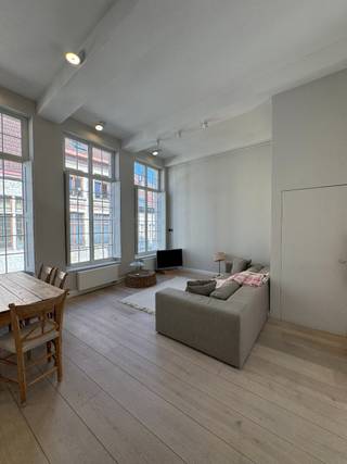 TE HUUR - GENT. Op een rustige en uiterst gegeerde ligging in het historische centrum van Gent bevindt zich dit prachtig duplex-appartement met twee slaapkamers en een aangenaam dakterras. Het appartement werd afgewerkt met oog voor detail en kwaliteit en straalt dankzij de stijlvolle materialen en warme inrichting een bijzonder gezellige sfeer uit.<br /><br />Via de inkomhal met gastentoilet bereikt u de ruime en lichtrijke leefruimte met gezellige eethoek en aansluitend een ingerichte keuken. Verder beschikt het appartement over een praktische bijkeuken/wasruimte. Op de verdieping bevinden zich twee volwaardige slaapkamers en een comfortabele badkamer voorzien van ligbad en douche. Het zonnige dakterras vormt een heerlijke plek om in alle rust te genieten.<br /><br />Een charmant en kwalitatief appartement voor wie stijlvol en rustig wil wonen in het hart van Gent.<br /><br />Huurprijs: € 1.875/maand + € 125/maand algemene kosten.
