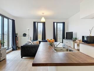 Modern en energiezuinig 2-slaapkamer appartement met veel licht en open verzicht. Het appartement omvat een inkomhal met gastentoilet, leefruimte...