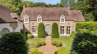 <p>Op een <strong>absolute toplocatie in het prestigieuze Kapellenbos</strong>, aan de Franselei 55, bevindt zich deze <strong>uitzonderlijke villa in kasteelhoevestijl</strong> op een <strong>residentieel perceel van ca. 5.700 m²</strong>. De ligging combineert <strong>uitstekende bereikbaarheid</strong> met <strong>volledige rust, privacy en groenbeleving</strong><span>.<br /><br /></span><strong>Indeling gelijkvloers</strong><br />De villa wordt bereikt via een <strong>monumentale kassei-oprijlaan</strong> en verwelkomt u in een <strong>ruime inkomhal</strong> met vestiaire en gastentoilet. Rechts bevinden zich twee <strong>stijlvolle leefruimtes met open haard</strong> (ca. <strong>55 m²</strong>) en zicht op de tuin. Links situeren zich de <strong>eetkamer</strong> (ca. <strong>20 m²</strong>) en de <strong>ruime eet-leefkeuken</strong> (ca. <strong>25 m²</strong>) met <strong>natuurstenen werkbladen, kookeiland en kwalitatieve toestellen</strong>, en met <strong>directe connectie naar terrassen en tuin</strong>. Aansluitend is er een <strong>volwaardige bijkeuken/wasplaats met douche</strong>.</p>
<p><strong>Indeling eerste verdieping</strong><br />De nachthal met vide geeft toegang tot <strong>vier slaapkamers en drie badkamers</strong>. De <strong>master bedroom</strong> (ca. <strong>25 m²</strong>) beschikt over een <strong>dressing en badkamer ensuite</strong>. De overige slaapkamers meten ca. <strong>18 m²</strong>, <strong>16 m²</strong> en <strong>14 m²</strong>. Eén van de badkamers is uitgerust met een <strong>sauna</strong>.</p>
<p><strong>Indeling tweede verdieping</strong><br />De tweede verdieping omvat een <strong>vijfde slaapkamer</strong> (ca. <strong>20 m²</strong>) met <strong>badkamer ensuite</strong>, ideaal als <strong>gastensuite of tienerkamer</strong>.</p>
<p><strong>Bijkomende ruimtes</strong><br />Een aparte zij-ingang geeft toegang tot een <strong>bureelruimte</strong> (ca. <strong>22 m²</strong>), een <strong>sportkamer</strong>, een <strong>logeerkamer/conciergerieruimte met badkamer</strong> en een <strong>dubbele inpandige garage</strong>, wat dit eigendom ook geschikt maakt voor <strong>praktijk of kantoor aan huis</strong>.</p>
<p><strong>Tuin</strong><br />De <strong>fraai aangelegde parktuin</strong> biedt <strong>volledige rust en privacy</strong> en is ingericht met <strong>strakke haagstructuren, volwassen bomen, een grote vijver, meerdere zonneterrassen</strong> en een <strong>eikenhouten bijgebouw</strong>. Een <strong>poort naar de achtergelegen dreef</strong> versterkt het exclusieve domeinkarakter.</p>
<p><strong>Bijzonderheden</strong><br /><strong>Absolute topligging in Kapellenbos</strong>, <strong>perceel ca. 5.700 m²</strong>, <strong>kasteelhoevestijl</strong>, <strong>monumentale oprijlaan</strong>, <strong>open haard</strong>, <strong>kwalitatieve leefkeuken</strong>, <strong>5 slaapkamers en 4 badkamers</strong>, <strong>sauna</strong>, <strong>bureau- en praktijkmogelijkheden</strong>, <strong>dubbele inpandige garage</strong>, <strong>bijgebouw</strong>, <strong>parktuin met vijver</strong>, <strong>uitstekende privacy</strong>.</p>