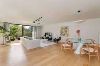 Verscholen in een uitzonderlijk groen en rustig parkdomein van maar liefst 5.783 m² bevindt zich dit stijlvolle en instapklare appartement van ca. 133 m². De residentie geniet van een gegeerde ligging in een charmante eenrichtingsstraat, op wandelafstand van de oude dorpskern van Schilde en de kerk.<br /><br />Bij het binnenkomen verwelkomt een verzorgde inkomhal u in de lichtrijke leefruimte met warm eiken parket. De royale woonkamer wordt gekenmerkt door een raampartij die een prachtig zicht biedt op de volwassen parktuin. Aansluitend bevindt zich een aangenaam terras van ca. 10 m², waar u in alle rust kunt genieten van het groene decor.<br />De naastgelegen, tijdloze witte keuken is uitgerust met kwalitatieve toestellen en beschikt over een praktische berging/wasplaats. Verder werd er voorzien in een gastentoilet met handenwasser, drie comfortabele slaapkamers op parket en een ruime badkamer voorzien van ligbad, toilet en dubbel lavabomeubel. Daarnaast is er een aparte douchekamer voorzien van lavabomeubel en douche.<br /><br />Het appartement verkeert in uitstekende staat van onderhoud en is volledig instapklaar. Alle leefruimtes zijn afgewerkt met kwaliteitsvol eiken parket; inkomhal, keuken, berging, badkamers en toilet zijn voorzien van duurzame tegelvloeren.<br /><br />Bij het appartement horen eveneens een ruime ondergrondse staanplaats (verplicht bij aan te kopen 15.000 euro) en een private berging. Daarnaast beschikt de residentie over een gemeenschappelijke fietsenberging. De maandelijkse bijdrage voor de gemeenschappelijke delen bedraagt circa €225 en omvat onder meer het onderhoud van het prachtige parkdomein dat toegankelijk is voor alle bewoners.<br /><br /><br /><br />Troeven:<br />Ruim appartement van ca. 133 m²<br />Parkdomein van 5.783 m²<br />Lichtrijke woonkamer met zicht op de parktuin<br />Terras van ca. 10 m²<br />Drie slaapkamers en twee badkamers<br />Vloerverwarming <br />Ondergrondse staanplaats en private berging <br />Gemeenschappelijke fietsenberging<br />Rustige topligging nabij het centrum van Schilde<br />EPC: 214 kWh/m² jaar – Label C<br />Instapklaar en uitstekend onderhouden<br /><br />Een unieke woonkans voor wie op zoek is naar ruimte, comfort, privacy en een uitzonderlijke groene omgeving op een toplocatie in Schilde.<br /><br />De het grondplan, het EPC en de asbestinventaris kan u reeds bekijken via de Wellimmo-site ('documenten')<br /><br />📩 Meer info of een bezoek: info@wellimmo.net<br />📞 03/225 00 68