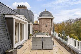 <p><span>Spacious castle apartment located in a unique location in the middle of the quiet park domain ‘Blauwhof’, near the center of Kapellen! The apartment includes an entrance hall, spacious living room with sunny terrace, dining room with enclosed terrace, separate kitchen, 2 bedrooms, 2 fitted bathrooms and 2 underground car parking spaces.</span></p><p><span> </span></p><p><span>LAYOUT</span></p><p><span> </span></p><p><span>Ground floor</span></p><p><span>The elevator takes you directly to the apartment. You enter a spacious entrance hall on epoxy floor, equipped with a guest toilet and checkroom. From the entrance hall you have access to the separate kitchen on epoxy floor, equipped with a stove hood, teppanyaki, built-in coffee machine, dishwasher, combi-oven/microwave, separate microwave, double fridge and sink.</span></p><p><span>Adjacent is a practical laundry room with ample storage cabinets and plumbing for a washer and dryer.</span></p><p><span>The dining room on parquet floor is accessible from the entrance hall and has an enclosed terrace and a useful storage cupboard.</span></p><p><span>A passage on parquet floor, with built-in closets, leads to the first bedroom on parquet floor, with built-in closets and a fully equipped bathroom on tiled floor, equipped with a bath, shower, double sink and toilet.</span></p><p><span>The second bedroom on parquet floor has an ensuite bathroom on tiled floor, equipped with a shower, single sink and toilet.</span></p><p><span> </span></p><p><span>Second floor </span></p><p><span>Through the wooden spiral staircase or by elevator you reach the second floor. Here there is a spacious and bright sitting area on parquet floor, with a cozy wood fireplace and a small kitchenette. From this room you have access to the sunny terrace with beautiful views of the greenery and the beautifully landscaped pond. </span></p><p><span> </span></p><p><span>Garage</span></p><p><span>The apartment has two underground car parking spaces: one enclosed garage box (mandatory to buy along for € 25,000) and one between lines (optional to buy along for € 25,000)</span></p><p><span> </span></p><p><span>Details</span></p><p><span>- Located in a coveted location: in a beautiful park domain ‘Blauwhof’ of 108.076 m², near the center of Kapellen and various amenities (restaurants, stores, schools, public transport,...). </span></p><p><span>- Living in a unique and classy castle.</span></p><p><span>- Elevator goes directly into the apartment (both ground and second floor).</span></p><p><span>- Spacious, sunny terrace with magnificent view of the greenery and the pond.</span></p><p><span>- The apartment has two underground parking spaces: one enclosed garage box (mandatory to buy along for € 25,000) and one between lines (optional to buy along for € 25,000).</span></p><p><span> </span></p><p><span> </span></p>