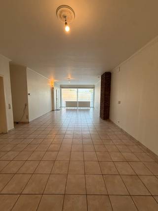 Ruim gelijkvloers appartement van 183m² (Volgens EPC, inclusief garage)  bestaande uit leefruimte met keuken, 2 slaapkamers, apart toilet, badkamer met bad, ruime garage en opbergplaats. Terras.<br />Maandelijkse huurprijs € 900/ maand. Geen syndickosten.