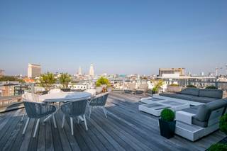 <div>
<div>
<div>
<p>This penthouse was renovated in 2017 by the Dutch interior architect Jan des Bouvrie. The apartment features a private elevator, a living area of 434 m², two large sun terraces totaling 130 m², three storage rooms, and one indoor parking space, with a second parking spot possibly available for purchase at €35,000. The entire apartment is secured with a keypad for triple security. There is colorful LED lighting, air conditioning, white high-gloss built-in cabinets, and Corian finishes. The open entrance hall on the sixth floor provides direct access to the large reception area, with a lounge and dining section, three designer gas fireplaces, and a fully equipped bar with Gaggenau appliances. These include a double fridge/freezer with ice maker, double wine fridge, professional coffee machine, combi-oven, dishwasher, and an instant hot water boiler. This floor also houses two bedrooms, each with a private bathroom equipped with a rain shower with mosaic tiles, double sink, and toilet. The master bedroom additionally features a double jacuzzi with built-in LED lighting. A floating staircase and an internal private elevator connect the sixth and seventh floors. On the seventh floor, there is a private lounge, dining area, library, kitchen with the same Gaggenau appliances as downstairs, and a third bedroom with a shower room. This floor has automatic sunshades and two sun terraces of 90 m² and 40 m². From here, you have a unique view of the Cathedral of Our Lady, the Boerentoren, and the city theater.</p>
</div>
</div>
</div>
<div>
<div></div>
</div>
<span><br /><br />Located in the heart of Antwerp city centre, this exclusive and luxurious duplex penthouse is a real feast for the eyes. Within walking distance of the famous Schuttershofstraat with its elegant shops and the Stadsschouwburg for optimal entertainment. Due to this ideal location, you can be in and out of the city in no time.<br /></span>
