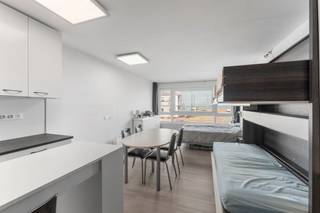 <p>Located in a well-maintained building just a short walk from the beach, this bright 40 m² studio offers a pleasant view towards the sea. Large windows provide plenty of natural light and a spacious, airy feel. The surrounding area will soon be further enhanced with the creation of a new green zone.</p>
<p>The living area was recently renovated and features a modern, fully equipped kitchen with quality appliances. The sleeping area is cleverly arranged with a fixed double bed and two fold-out single beds neatly integrated into a wall unit, allowing for optimal use of space. The bathroom includes a shower, washbasin and toilet.</p>
<p>With an energy-efficient EPC label B, this property offers a worry-free investment, ideal both for personal use and for rental purposes. Its peaceful residential location, close to the beach and tram, makes it an excellent coastal getaway.</p>
<p><strong>Extra feature:</strong> possibility to purchase a nearby garage or storage unit, perfect for bicycles or beach equipment.</p>
<p><strong>Highlights</strong></p>
<ul>
<li>
<p>Quiet location within walking distance of the sea and tram</p>
</li>
<li>
<p>Large window providing abundant natural light</p>
</li>
<li>
<p>Partial sea view and outlook over the new green area</p>
</li>
<li>
<p>Recently renovated, fully equipped kitchen</p>
</li>
<li>
<p>Smart sleeping area with multiple bed options</p>
</li>
<li>
<p>Energy-efficient: EPC label B</p>
</li>
<li>
<p>Optional garage or storage unit nearby</p>
</li>
</ul>
<p>A bright and move-in-ready studio in a prime coastal location, perfect as a second home or as a low-maintenance investment.</p>