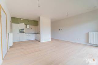 In dit praktisch ingedeelde appartement geniet u van een open en zeer lichtrijke leefruimte, dankzij de grote raampartijen die zorgen voor een aangename lichtinval doorheen de dag. De leefruimte sluit naadloos aan op de open keuken en biedt toegang tot een gezellig terras met zicht op de speeltuin en het omliggende groen – ideaal voor wie graag buiten leeft of kinderen heeft.
Het appartement beschikt over twee slaapkamers van respectievelijk 13 m² en 7 m². De ruime badkamer is voorzien van een douche, en in de inkomhal vindt u ingebouwde kasten die zorgen voor extra opbergruimte en een nette uitstraling.
Kortom, een comfortabel en energiezuinig appartement met doordachte indeling, perfect voor jonge gezinnen, koppels of wie gewoon net dat tikkeltje meer ruimte zoekt.