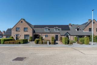 <p>Op een fijne en goed bereikbare locatie aan de Gilseinde in Ravels bevindt zich deze veelzijdige eigendom. Van buitenaf lijkt het een aangename en charmante woning, maar achter de woning ontvouwt zich een verrassend ruim geheel met een uitzonderlijk ruime tuin, een groot terrein, diverse (bedrijfs)gebouwen, werkplaatsen en kantoorruimtes.</p>
<p>Deze eigendom is bijzonder interessant voor paardenliefhebbers, tuinierbedrijven en loonwerkers. Daarnaast biedt ze een ideale opportuniteit voor ondernemers, zelfstandigen en iedereen die wonen en werken wil combineren. Dankzij de ruime opzet en de vele mogelijkheden vormt deze eigendom een mooie combinatie van wooncomfort en professionele ruimte.</p>
<p><strong>Gelijkvloers<br /></strong>Vanuit de inkomhal heeft u toegang tot de woonkamer, maar ook tot de slaapkamer op de begane grond en de badkamer. Deze praktische indeling maakt gelijkvloers wonen perfect mogelijk.</p>
<p>De slaapkamer beschikt over een doorloop naar de dressing en badkamer met ligbad, douche, dubbele wastafel en stoomcabine.<br /><br />De woonkamer vormt het hart van de woning en beschikt over een indrukwekkende hoge nok, sfeervolle schouw met gashaard en open vide met zicht op de verdieping. De open keuken is uitgerust met kwalitatieve Miele-toestellen en werd enkele jaren geleden vernieuwd. Aansluitend zijn er een voorraadberging, wasplaats en toilet.<br /><br />Extra voorzieningen zijn o.a.: zonnepanelen met batterij, carport met laadpaal, centrale stofzuiginstallatie, alarmsysteem, regenwaterput aangesloten op toilet en wasmachine, elektrische zonwering en kruipruimte.<br /><br /><strong>Verdieping<br /></strong>De ruime open vide met stijlvolle balustrade zorgt voor een mooie verbinding tussen de leefruimtes. De verdieping biedt mogelijkheden als hobbyruimte, kantoor of extra slaapkamers. Er zijn ingebouwde kasten, een keukenhoek met spoelbak en twee slaapkamers met wastafel. Eén slaapkamer geeft toegang tot een extra zolderkamer.<br /><br /><strong>Buitenruimte<br /></strong>Van buitenaf is nauwelijks te vermoeden welke omvang en mogelijkheden zich achter de woning bevinden. Deze groene oase biedt volop privacy, sfeervolle zitplekken en tal van mogelijkheden om te ontspannen.</p>
<p>De buitenruimte beschikt o.a. over een ruim aangelegde tuin, tuinhuis, vijver, moestuin/groentetuin, diverse fruitbomen, prachtige treurwilg, buitenverlichting, groene zones voor dieren en een geboorde grondwaterput van 12 m diep.<br /><br /><strong>Brasserie/feestzaal<br /></strong>Een bijkomende troef is de aparte brasserie/feestzaal van ca. 125 m² met bar en toiletvoorziening. Aan de voorzijde van de brasserie bevindt zich een sfeervolle pergola met leilinden en aansluitend een jeu-de-boulesbaan.<br /><br /><strong>Loods/werkplaats/kantoren<br /></strong>Via de achtertuin bereikt u het achterliggende terrein met bedrijfsgebouwen. De loods met verdieping is geschikt voor diverse (professionele) activiteiten. Dankzij de aparte toegangsweg is het terrein rechtstreeks bereikbaar.<br /><br />Het gebouw beschikt over meerdere ruimtes, een vrije hoogte tot ca. 5 m, elektrische toegangspoorten, krachtstroom, kantoorruimtes, toilet en een keuken. Daarnaast is er een aparte loods van circa 104 m² met schuifpoorten en krachtstroom. Tevens is er ruime parkeergelegenheid op het terrein.<br /><br /><strong>Een unieke kans<br /></strong>Deze veelzijdige eigendom is eigenlijk moeilijk volledig te omschrijven in één advertentie.</p>
<p>De combinatie van de aangename woning, de indrukwekkend ruime tuin, het achterliggende terrein, de verschillende gebouwen, kantoren, werkplaatsen, opslagmogelijkheden en de vele extra voorzieningen moet u vooral zelf komen ontdekken.</p>
<p>Een bezoek ter plaatse is dan ook absoluut de moeite waard.<br /><br />Meer info of een bezichtiging? Contacteer ons via: +32 (0) 14 65 03 79 of info@verlouwvastgoed.be.</p>