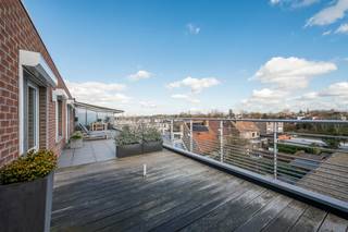 [[ DIT PAND NEEMT DEEL AAN DE ERA OPEN HUIZEN DAG OP 13/6 VAN 9:30 TOT 10:30 ]]
<p>Ben je opzoek naar een rustig gelegen dakappartement dat tot in de puntjes onderhouden werd? Lees hier dan zeker even verder!</p>

<p>Dit prachtige appartement is klaar om meteen van te genieten en bevindt zich in een verzorgd gebouw. Met twee indrukwekkende dakterrassen van elk 70m² biedt dit appartement volop ruimte om buiten te leven en te ontspannen. Dit zijn slecht enkele troeven van deze woning!</p>

<p>Indeling:</p>

<p>Bij binnenkomst word je verwelkomd in de inkomhal (12m²), die toegang geeft tot de zonovergoten woonkamer met een moderne open keuken (54m²). De keuken is voorzien van alle nodige toestellen om je heerlijke maaltijden voor te bereiden. Vanuit de woonkamer stap je direct op de twee unieke terrassen, elk aan een zijde van het appartement. Zo geniet je de hele dag van de zon en kan je in alle rust ontspannen. Verder beschikt het appartement over drie comfortabele slaapkamers (7-8-16m²), een ruime badkamer (12m²), een aparte wasplaats en een gastentoilet. Alles is tot in de puntjes afgewerkt en voorzien van alle comfort. Geniet van de rust, de zon en het uitzicht, terwijl je toch alle voorzieningen binnen handbereik hebt. Dit is een zeldzame kans voor wie houdt van modern wonen in een groene en serene omgeving. Bij het appartement hoort een kelderberging en dient de autostaanplaats bij aangekocht te worden voor €25.000.</p>

<p>Zou deze woning wel eens jouw nieuwe thuis kunnen worden? Laat ons dan snel iets weten en plan een bezoek in!</p>