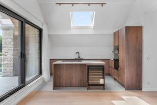 Wij stellen u graag dit uitzonderlijk ruime appartement voor, gelegen op de bovenste verdieping van een kleinschalig gebouw met slechts twee appartementen, waar hedendaags wooncomfort en een hoogwaardige afwerking centraal staan. Via de privatieve inkomhal met privatieve lift komt u terecht in de lichtrijke leefruimte met open keuken, afgewerkt met kwalitatieve materialen en ingemaakte maatkasten die zorgen voor een stijlvolle en tijdloze uitstraling. Met een bewoonbare oppervlakte van 141 m² biedt deze woonst bijzonder veel ruimte. De drie volwaardige slaapkamers maken het appartement ideaal voor gezinnen, thuiswerk of wie extra logeerruimte wenst. Daarnaast beschikt de woning over twee smaakvol ingerichte badkamers. Ook technisch werd niets aan het toeval overgelaten: vloerverwarming, een warmtepomp, ventilatiesysteem type D en zonnepanelen zorgen voor comfort en een energiezuinig karakter. Buiten geniet u van een doorlopend balkon langs de zijkant van het gebouw en een ruim terras dat rechtstreeks toegankelijk is vanuit de woonkamer. De aankoop van een dubbele parkeerplaats op de binnenplaats is verplicht aan € 35.000. Winkels, scholen en openbaar vervoer bevinden zich in de onmiddellijke omgeving, terwijl u dankzij de vlotte verbinding met de E314 snel de belangrijkste invalswegen bereikt. Kortom, een instapklare en bijzonder ruime woonst die kwaliteit, comfort en bereikbaarheid perfect combineert. Interesse? Contacteer ons via info@homies.be of 016 22 82 22.