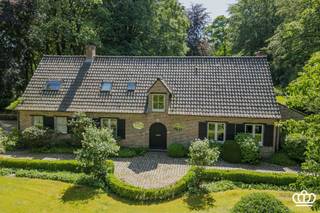 <p><span>Zeer stijlvolle en hoogwaardig afgewerkte villa gelegen in Kapellen-Bos, met o.a. een lichtrijke en ruime leefruimte, luxueuze leefkeuken met orangerie, 3 slaapkamers, 2 badkamers en een dubbele inpandige garage, op een zuidwestgericht perceel van ca. 4.577 m², voorzien van een fraai aangelegde tuin, verwarmd zwembad, meerdere terrassen en een eikenhouten bijgebouw met carport voor 3 wagens.</span></p><p><span> </span></p><p><span>INDELING</span></p><p><span>Gelijkvloers </span><span><br />Bij het binnenkomen betreedt u de inkomhal op tegelvloer, voorzien van een vestiaire en een gastentoilet met handenwasser. Via dubbele glazen stalen deuren bereikt u de sfeervolle cocktail room met ingemaakte kasten. Vanuit hier heeft u toegang tot de leefruimte, eveneens op tegelvloer, met ruime zit- en tv-hoek en een open haard. Aansluitend bevindt zich een verhoogde bureauruimte op parket, momenteel ingericht als speelruimte. Verder is er een kwalitatief ingerichte leefkeuken met ruim kookeiland en een prachtige orangerie waarin de eethoek is ondergebracht. Vanuit alle ruimtes op het gelijkvloers geniet u van een aangenaam zicht op het groen en de fraai aangelegde tuin. De keuken is voorzien van een ontbijthoek en alle ingebouwde toestellen, waaronder een spoelbak met Quooker kraan, inductiekookplaat met down-draft dampkap, wijnkoelkast, koelkast, combi-oven, stoomoven en vaatwasser. Aansluitend is er een bijkeuken met ingemaakte kasten, combi-microgolfoven, oven, ingebouwde vriezer, wasbak en voorzieningen voor wasmachine en droogkast op hoogte. Verder beschikt u over een dubbele inpandige garage.</span></p><p><span>Eerste verdieping</span><span><br />Via de houten trap bereikt u de nachthal. De master bedroom op parketvloer beschikt over ingemaakte kasten en een ensuite badkamer met dubbele regendouche en dubbele wastafel, aangevuld met een dressing. Daarnaast zijn er nog twee slaapkamers, eveneens op parketvloer, waarvan één met ingemaakte kasten. De tweede badkamer is voorzien van een ligbad. Op deze verdieping is er ook een apart toilet.</span></p><p><span>Zolder </span><span><br />Via een vlizotrap in de nachthal heeft u toegang tot een ruime bergzolder over de volledige breedte van de woning. </span></p><p><span>Kelder </span><span><br />De woning is volledig onderkelderd d.m.v. kruipruimte. </span></p><p><span>Tuin</span><span><br />De villa is gelegen op een zuidwest geörienteerd perceel van ca. 4.577 m² met een unieke bomenstand en veel privacy. Via de ruime kasseioprijlaan bereikt u zowel het eikenhouten bijgebouw met carport voor drie wagens en tuinberging, als de dubbele inpandige garage. In het bijgebouw bevindt zich tevens de technische installatie van het zwembad. Achteraan geniet u van een ruim open terras, een overdekt houten terras en een fraai aangelegde tuin voorzien van een verwarmd zwembad met warmtepomp.</span></p><p><span>Bijzonderheden<br /></span><span>- Gelegen op een gegeerde locatie: tussen het centrum van Heide en Kapellen nabij scholen, winkels, openbaar vervoer,…</span></p><p><span>- Recent zeer stijlvol gerenoveerd met gebruik van hoogwaardige materialen </span></p><p><span>- EPC B-label, elektriciteit is conform en asbestveilig</span></p><p><span>- Ruime, zuidwest georiënteerde tuin met meerdere terrassen en een verwarmd zwembad met warmtepomp en solar deck </span></p><p><span>- Veel parkeergelegenheid dankzij ruime oprit, dubbele inpandige garage en carport voor 3 wagens </span></p><p><span>- 24 zonnepanelen met groenestroomcertificaten </span></p><p><span>- De oppervlakten zijn indicatief en gebaseerd op het EPC.</span></p><p><span> </span></p>