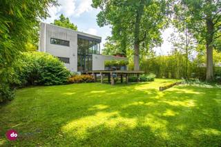 <p><span>An architectural gem in the Lievekensbossen in Schiplaken</span></p><p><span> </span></p><p><span>Located in the green and sought-after surroundings of the Lievekensbossen in Schiplaken, centrally situated between Leuven, Mechelen, Antwerp, and Brussels, stands this forward-thinking architect-designed home from 1994. A unique villa where tranquility, modern design, and an exceptional sense of light come together.</span></p><p><span> </span></p><p><span>Designed by architect Frederic Leers, this home seamlessly blends aesthetics and functionality. High-quality materials such as granite in the kitchen, marmoleum in the entryway, and warm beech in the living area give the entire home a timeless and refined look. Large windows allow natural daylight to flood in, creating a dynamic, warm atmosphere throughout the entire home.</span></p><p><span> </span></p><p><span>On the ground floor, you enter a spacious living area with a sleek and modern character. Thanks to the underfloor heating, the generous windows, and the automatic blinds, you can enjoy maximum comfort and flexibility in the layout here. The open kitchen forms a harmonious whole with the living area but can easily be closed off if desired via a stylish, movable cabinet.</span></p><p><span> </span></p><p><span>The first floor features three full-sized bedrooms. The Master Bedroom, with an adjoining bathroom equipped with both a bathtub and shower as well as elegant stainless steel designer sinks, is a true showstopper.</span></p><p><span> </span></p><p><span>The top floor, designed as an open loft with built-in cabinets, offers a perfect balance between work and relaxation. Here you have a versatile space, ideal as an office or cozy TV corner, which opens onto the spacious terrace via an aesthetic light bridge.</span></p><p><span> </span></p><p><span>The home also features a practical laundry room and a spacious indoor garage with room for two cars.</span></p><p><span> </span></p><p><span>Finally, the home has an EPC rating of C, which further highlights the harmonious combination of energy efficiency, modern comfort, and architectural quality.</span></p><p><span> </span></p><p><span>Let yourself be surprised by this unique living experience and schedule your visit today.</span></p><p><span> </span></p><p><span>015 20 36 00 - <span>info@domoxim.be</span></span></p><p><span> </span></p><p><span>domoXim. Where dreams come home!</span></p><p><span> </span></p><p><span>Do you want to know the value of your </span><span>own</span><span> home? We’d be happy to advise you.</span></p>