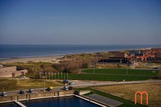<strong>An iconic seaside address</strong><br />Located in the prestigious <strong>Ensor Tower II</strong>, in the vibrant waterfront district of <strong>Oosteroever</strong> in <strong>Oostende</strong>, this <strong>exceptional luxury apartment</strong> on the 12th floor offers breathtaking panoramic views over the North Sea, the dunes and the coastline.<br />With a living area of <strong>130 m²</strong> and <strong>two generous terraces</strong>, this remarkable residence perfectly combines <strong>modern architecture, high-end comfort and an exclusive seaside lifestyle</strong>.<br /><br /><strong>Bright living space with spectacular sea views</strong><br />Upon entering, you are welcomed by an elegant <strong>entrance hall with guest toilet</strong>.<br />The <strong>spacious, light-filled living room</strong> features large floor-to-ceiling windows offering <strong>stunning panoramic views of the sea and surrounding dunes</strong>.<br />The living area opens directly onto a <strong>beautiful 17 m² terrace</strong>, the perfect setting to relax while enjoying the endless coastal scenery.<br /><br /><strong>Contemporary open kitchen with premium finishes</strong><br />The <strong>beautifully designed open kitchen</strong> seamlessly integrates into the living space and features high-end appliances and refined materials.<br />Combining <strong>sleek contemporary design with practical functionality</strong>, it is ideal for both everyday living and entertaining guests.<br /><br /><strong>Master suite with breathtaking sea views</strong><br />The <strong>master bedroom</strong> is a private sanctuary with <strong>magnificent views of the sea</strong>.<br />It is complemented by a <strong>luxurious bathroom with walk-in shower</strong>, where you can even enjoy the sea view while showering.<br /><br />The suite also includes:<br />a <strong>spacious dressing room</strong><br />a <strong>private toilet</strong><br /><br />A perfect blend of <strong>privacy, comfort and elegance</strong>.<br /><br /><strong>Two additional bedrooms and second terrace</strong><br />The apartment further offers <strong>two additional bedrooms</strong>, ideal for family, guests or a stylish home office.<br />These rooms provide access to a <strong>second terrace of 10 m²</strong> and share a <strong>modern bathroom with shower</strong>.<br />A <strong>spacious storage room</strong> adds further practicality.<br /><br /><strong>Energy-efficient and future-proof living</strong><br /><br /><span>Built in <strong>2023</strong>, the apartment meets the highest standards of energy efficiency and modern comfort:</span><br /><span><strong>Underfloor heating connected to the district heating network</strong></span><br /><span><strong>Energy label A – 49 kWh/m²</strong></span><br /><span>High-quality insulation and advanced technologies</span><br /><br />Ensuring <strong>excellent comfort and low energy consumption</strong>.<br /><br /><span><strong>Key features</strong></span><br /><span>Living area: <strong>130 m²</strong></span><br /><span>Terraces: <strong>17 m² + 10 m²</strong></span><br /><span><strong>Optional underground parking space nr 17 available</strong></span><br /><span>Possibility to acquire the interior furnishings</span><br /><span>Cadastral income: € 1.221</span><br /><br /><strong>A rare opportunity on the Belgian coast</strong><br />This outstanding property combines <strong>luxury finishes, contemporary architecture and breathtaking sea views</strong>.<br /><br />A truly <strong>exclusive opportunity for those seeking a prestigious apartment in Ostend</strong>.
