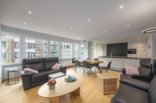 Op een <strong>uitmuntende ligging</strong> op <strong>wandelafstand</strong> <strong>van het strand </strong>en <strong>het Kursaal</strong> bevindt zich dit <strong>hoogwaardig afgewerkte appartement</strong> van <strong>109 m² bewoonbare oppervlakte,</strong> een echte zeldzaamheid in deze buurt. <strong>Comfort, licht en kwaliteit staan hier centraal.</strong><br /><br />De <strong>ruime en lichtrijke leefruimte</strong> sluit naadloos aan op de <strong>moderne open keuken</strong>, uitgevoerd met <strong>duurzame en kwalitatieve materialen</strong>. Het appartement beschikt over <strong>twee volwaardige slaapkamers</strong>, elk voorzien van <strong>ingemaakte maatkasten.</strong> <br /><br />De <strong>stijlvolle badkamer</strong> is uitgerust met een <strong>inloopdouche, wastafel en toilet</strong>. Verder is er een <strong>verzorgde inkomhal met vestiaire</strong>, een <strong>apart gastentoilet</strong> en een <strong>praktische berging met wasruimte. </strong>Het appartement heeft toegang tot <strong>balkons aan de voor- als achterzijde.</strong><br /><br />Extra troeven zijn de <strong>gerenoveerde</strong> <strong>inpandige garage </strong>met <strong>elektrische poort (verplicht bij te kopen)</strong>, een <strong>ruime privatieve kelder</strong> en een <strong>gemeenschappelijke fietsenstalling.</strong><br />Bij de renovatie werd bewust gekozen voor <strong>duurzame isolatie en energiezuinige technieken,</strong> wat resulteert in een <strong>EPC-label A.</strong> Het appartement is <strong>asbestveilig, de elektriciteit is conform</strong> en het geheel is <strong>volledig instapklaar</strong> — er zijn <strong>geen werken nodig.</strong><br /><br />In overleg met de eigenaars is het overnemen van (een deel van) het meubilair bespreekbaar, wat dit aanbod extra aantrekkelijk maakt.<br />Een unieke kans voor wie luxueus, zorgeloos en energiezuinig wil wonen op een absolute toplocatie aan zee.