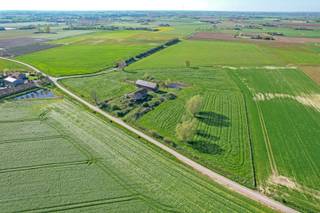 Unieke casco woning op 2ha grond. Een uitzonderlijke casco woning gelegen in het landelijke Lo-Reninge, midden in het groen op een prachtig perceel van 2 hectare. Deze woning is opgetrokken met oog voor kwaliteit en architectuur, en bevindt zich momenteel in ruwbouwfase. De woning valt onmiddellijk op door haar moderne uitstraling, de overvloed aan grote raampartijen en de unieke lichtinval die in elke ruimte voelbaar is. Dankzij de volledige onderkeldering beschikt deze woning over een enorme extra oppervlakte die voor diverse doeleinden kan worden benut zoals opslag, hobbyruimte, wellness of extra woonlagen. Rondom het huis geniet je van weidse uitzichten en volledige privacy, omringd door uitgestrekte velden en een gevoel van rust dat je zelden nog vindt. Op het domein bevinden zich ook meerdere bijgebouwen die perfect kunnen dienen als opslagruimte, werkatelier of als stalling voor dieren, wat deze eigendom uitermate geschikt maakt voor wie droomt van een landelijke woonst met ruimte voor hobby’s of kleinschalige dierenhouderij. De locatie combineert het beste van twee werelden: een landelijke en rustige omgeving met tegelijk een vlotte bereikbaarheid naar de kust en omliggende steden. Deze woning biedt een zeldzame kans voor wie op zoek is naar ruimte, vrijheid en de mogelijkheid om zelf de afwerking volledig naar eigen smaak te bepalen. Verkoop onder registratierechten. Foto 2,4,5,9,11 & 20 zijn foto's die bewerkt werden om een voorbeeld te geven hoe de woning kan worden ingericht.
