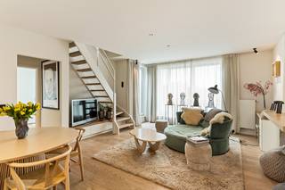 <strong>Luxueus en smaakvol afgewerkt dakappartement in het centrum van Schilde!</strong><br /><br />In het bruisende centrum van Schilde, nabij alle winkels, openbaar vervoer en scholen, vinden we in een recent gebouw (bouwjaar 2016) dit prachtige duplex appartement.<br /><br />Het appartement werd in 2019 integraal gerenoveerd, onder begeleiding van een interieurarchitect. De renovatie werd uitgevoerd met oog voor detail, praktisch comfort en uitsluitend mits gebruik van hoogwaardige materialen. Je kan dit appartement dan ook gerust het neusje van de zalm noemen als het op afwerking aankomt.<br /><br />Via een veiligheidsdeur betreden we de inkomhal op parket. Meteen op onze linkerzijde bevindt zich het gastentoilet met mortex vloer alsook een op maat gemaakt meubel met handenwasser.<br /><br />Wanneer we doorlopen krijgen we meteen zicht op de lichte en open leefruimte met keuken (+/- 40m²).  <br />De leefruimte werd volledig voorzien van een parketvloer. Verder werd een volledige wand met praktische ingemaakte kasten ingericht, is er een op maat gemaakt bureaumeubel aanwezig alsook een meubel op maat waarin o.a. de digicorder kan worden opgeborgen zonder dat de draden zichtbaar blijven.<br /><br />De open keuken geniet een high-end afwerking in natuurhout en calacatta marmer en werd volledig uitgerust met AEG toestellen: inductiekookplaat, combi-oven/microgolf , koelkast met vriesvak en dampkap). Bovendien werd de keuken tevens voorzien van een praktische toog.<br /><br />Aansluitend aan de leefruimte alsook keuken bevinden zich 2 terrassen (2,8m² en 6m²) met zowel middag als avondzon.<br /><br />Op dit niveau bevinden zich verder een slaapkamer (12,5m²) welke werd uitgerust van ingemaakte kasten. Vanuit deze kamer heb je , net zoals vanuit de leefruimte, toegang tot het ruimste terras. Verder is er een technische ruimte/wasberging aanwezig alsook een ruime badkamer welke voorzien werd van inloopdouche, inbouwspots en  lavabomeubel.<br /><br />De bovenverdieping van het appartement bereiken we via een maatwerk trap vanuit de leefruimte. Dit niveau (+/- 48m²) werd volledig voorzien in mortex , de kasten en muren werden van een speciale schildertechniek voorzien die aansluit bij de vloerafwerking. Deze verdieping bestaat uit de master bedroom (met airco) , apart toilet, ensuite dressing en badkamer. De badkamer werd ingericht met 2 lavabomeubels met indirecte verlichting op maat, een groot design ligbad alsook een dubbele douche.<br /><br />Dit appartement biedt op gebied van afwerking en comfort werkelijk alles wat je maar wensen kan en vormt hierdoor een unieke buitenkans.<br /><br />+ Er bestaat de mogelijkheid tot overname van een huurcontract voor een ruime garagebox met berging in het complex.<br /><br />Wenst U een bezoek af te leggen aan dit prachtige appartement?  Wij zijn bereikbaar op het nummer 03 337 50 70<strong> </strong>om een afspraak in te plannen of via <strong>info@vbvastgoed.be</strong>