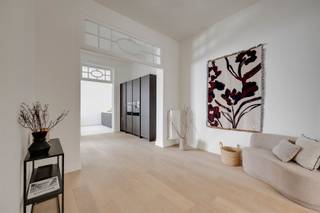 <p>Karakter van toen, comfort van nu. In een rustige straat midden in Sint-Andries ontdek je dit uitzonderlijk ruime duplexappartement van ca. 179 m², in 2026 volledig gerenoveerd met respect voor zijn oorspronkelijke architectuur.<br />Gelegen met de Kloosterstraat om de hoek, het KMSKA en ’t Zuid op wandelafstand en tegelijk de historische binnenstad vlakbij. Koffiebars, restaurants, galeries, winkels en dagelijkse voorzieningen liggen direct in de buurt.</p><p>Hoge plafonds, sierlijke glas-in-looddetails en een monumentale natuurstenen schouw geven de leefruimtes hun authentieke uitstraling. De lichte eiken vloer, strakke maatkeuken en eigentijdse badkamers zorgen voor de moderne tegenhanger. Geen standaard renovatie, maar een woning waar oud en nieuw bijzonder mooi samenvallen.</p><p>• Totaalrenovatie 2026<br />• 4 slaapkamers & 2 badkamers<br />• Authentieke glas-in-looddetails & natuurstenen schouw<br />• Private en aangelegde stadstuin<br />• EPC-label B<br />• Mogelijkheid tot aankoop garagebox aan € 35.000</p><p>De woning beslaat het gelijkvloers en de eerste verdieping van een kleinschalig gebouw met slechts drie units. Vooraan bevindt zich de royale woonkamer, gevolgd door een tweede leefruimte en de eetkamer. Achteraan vormt de keuken samen met de eetplaats het dagelijkse hart van de woning. Grote glaspartijen trekken hier het daglicht naar binnen en geven rechtstreeks toegang tot de aangelegde stadstuin: een verrassend rustige en groene plek midden in de stad.<br />Op de verdieping bevinden zich vier volwaardige slaapkamers en twee badkamers. De master beschikt over een ruime ensuite badkamer met ligbad, inloopdouche en dubbele wastafel. Een tweede douchekamer biedt extra comfort voor gezin of gasten. Ook praktisch zit het goed, met een aparte berging voor wasmachine en droogkast en een privatieve kelderberging.</p><p>Een stadstuin, bijna 180 m² woonruimte én het karakter van een herenhuis: die combinatie vind je niet elke dag in hartje Antwerpen.</p><p>Kom ze vooral zelf ervaren. Plan je bezoek via Sinjoor: 03 283 05 00 of stad@sinjoor.be.</p>