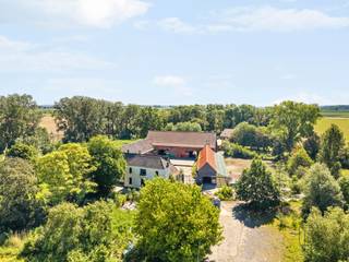 Ontdek het uitzonderlijke potentieel van Domaine de Jaurieu — een iconisch domein waar charme, authenticiteit en commerciële mogelijkheden naadloos samenkomen op een prachtig terrein van een 4700m2, (mogelijkheid 3 hectare extra bij te kopen).
Achter de indrukwekkende oprijlaan ontvouwt zich een unieke eigendom met een karaktervolle historische vierkantshoeve rond een sfeervol binnenplein en terras, omgeven door groen, een idyllische vijver en ruime parkeermogelijkheden.
Dit veelzijdige domein biedt vandaag al een sterke uitbatingsbasis, maar vooral een zeldzaam toekomstpotentieel voor ondernemers, investeerders of hospitality-concepten die op zoek zijn naar een locatie met uitstraling én mogelijkheden.
Het domein beschikt over alle nodige vergunningen voor het organiseren van evenementen tot 400 personen, de uitbating van een restaurant/taverne met overnachtingsmogelijkheden, een feestzaal en het houden van hoevedieren. Dankzij de parkingcapaciteit van maar liefst 230 wagens is het domein bovendien perfect uitgerust voor grootschalige events, seminaries, huwelijksfeesten, bedrijfsevents of exclusieve hospitalityconcepten.
Met meer dan 2.400 m² bruikbare binnenruimte biedt deze eigendom talloze exploitatemogelijkheden: van eventlocatie, hotel- en restaurantuitbating tot wellnessconcept, retreat, co-housingproject, seminariecentrum of exclusieve privéresidentie met professionele activiteit.
Een zeldzame opportuniteit voor wie op zoek is naar een karaktervolle toplocatie met geschiedenis, uitstraling en uitzonderlijk veel ontwikkelingspotentieel.