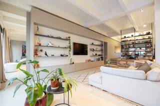 <p>Deze indrukwekkende loft van maar liefst 325 m², met terras en binnentuin, is een zeldzame vondst in het hart van Antwerpen — op een steenworp van Park Spoor Noord en het Eilandje.</p><p>De voormalige pakhuizen van de Van de Wervestraat ademen geschiedenis, maar binnenin wacht pure moderniteit. Denk aan hoge plafonds, massieve draagstructuren en overvloedig daglicht, gecombineerd met tijdloze materialen en doordacht design.<br />Hier woon je in een bruisende buurt vol creatieve energie — tussen kunstgalerijen, hippe horeca en vernieuwde stadspleinen. Alles wat het Antwerpse stadsleven zo boeiend maakt, ligt letterlijk aan je voeten.</p><p>Waarom je hier wil wonen<br />•    Uitzonderlijke loft van 325 m²<br />•    Terras én gemeenschappelijke binnentuin<br />•    Designinterieur met maatwerk en hoogwaardige materialen<br />•    Open leefruimte met imposante plafondhoogte en veel licht<br />•    Mogelijkheid tot ruime inpandige autostaanplaats (€55.000)</p><p>Bij het binnenkomen zet de hoge plafonds en het overvloedige licht meteen de toon.</p><p>De inkomhal met vestiairekast en gastentoilet leidt naar een tweede slaapkamer — perfect als gastenkamer of kantoor.</p><p>De royale leefruimte vormt het hart van de loft: open, warm en gelaagd.<br />De open keuken is een statement van klasse: natuurstenen werkblad, kamerhoge fineerkasten en hoogwaardige toestellen. De leefruimte geeft toegang tot het terras, vanwaar je uitkijkt op de groene binnentuin — een oase midden in de stad.</p><p>Een subtiele kastenwand scheidt de leefruimte van de master suite en creëert rust en privacy. De master beschikt over een dressing, een luxueuze badkamer met vrijstaand bad, dubbele wastafel en inloopdouche — hotelgevoel inbegrepen.</p><p>Deze loft is niet zomaar een woonst, het is een beleving.<br />Ruimte, licht en verfijning in één strak geheel, met respect voor het industriële karakter van het gebouw.</p><p>Ontdek deze exclusieve loft en plan je bezoek via sinjoor.be.</p><p><span><span> </span></span></p>