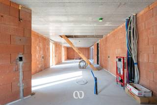 Unieke casco woonbeleving met eindeloze mogelijkheden<br /><br />Deze voormalige vierkantshoeve biedt met maar liefst ca. 210 m² bewoonbare oppervlakte een bijzonder ruime basis voor wie op zoek is naar een woning die volledig naar eigen wensen kan worden ingericht. Dankzij de huidige casco-afwerking krijgt u hier de unieke mogelijkheid om zelf de indeling, afwerking en woonbeleving te bepalen.<br /><br />Van een ruime gezinswoning met royale leefruimtes en meerdere slaapkamers tot een combinatie van wonen en werken, een praktijkruimte voor een vrij beroep of een vorm van co-housing: hier zijn bijzonder veel mogelijkheden. Ook een aparte toegang tot de bovenverdieping behoort tot de mogelijkheden, waardoor verschillende woon- of gebruiksconcepten perfect denkbaar zijn.<br /><br />De woning is reeds voorzien van en aangesloten op alle nodige technieken. De binnenmuren dienen nog geplaatst te worden, waardoor u niet gebonden bent aan een bestaande indeling. U bepaalt zelf waar de leefruimtes, slaapkamers, bureauruimtes, badkamer(s) en eventuele praktijk- of hobbyruimtes komen. Ook op vlak van afwerking kunt u volledig uw eigen stijl en voorkeuren volgen.<br /><br />De combinatie van de royale oppervlakte, de karaktervolle structuur van de voormalige vierkantshoeve en de uitzonderlijke vrijheid in indeling maakt dit een pand met een bijzonder groot potentieel.<br /><br />Daarnaast beschikt de woning over een overdekte autostaanplaats, een aangename tuin en een afzonderlijke bergruimte die reeds voorzien is van de nodige aansluitingen.<br /><br />Een bijkomende troef is dat deze aankoop kan genieten van het 6%-btw-regime.<br /><br />Kortom: een unieke kans voor wie niet op zoek is naar een standaardwoning, maar naar een ruime woonbasis die volledig kan worden afgestemd op de eigen wensen, levensstijl en toekomstplannen. Is dit project iets voor u, twijfel dan niet om ons te contacteren!