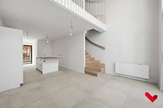 Bent u op zoek naar een stijlvolle en energiezuinige woning in hartje Leuven waar comfort centraal staat?<br />Bezoek dan snel deze prachtige nieuwbouwwoning met hoogwaardige afwerking in het prestigieuze project Burenberg.<br /><br />De woning beschikt over 3 slaapkamers, 2 badkamers, een privatieve parkeerplaats met laadpaal, 2 kelderbergingen, 2 fietsenstallingen en een bakfietsplaats.<br /><br />Bij het betreden van de woning komt u in een ruime inkomhal met gastentoilet. Op het gelijkvloers bevindt zich verder een praktische berging met aansluiting voor een wasmachine en een volledig uitgeruste open keuken met kookeiland. <br />De keuken is volledig geïnstalleerd met kwalitatieve toestellen zoals een BORA-inductiekookplaat. Aansluitend vindt u de lichtrijke eetruimte met indrukwekkende mezzanine en een plafondhoogte van maar liefst 5,50 meter, wat zorgt voor een uitzonderlijk ruimtelijk gevoel. Via de eetruimte heeft u toegang tot het terras.<br /><br />Op de eerste verdieping bevindt zich de gezellige leefruimte met een mooi open zicht en veel lichtinval door de grote raampartijen. <br />Verder vindt u hier een apart toilet, de eerste badkamer met douche en de eerste slaapkamer.<br />De tweede verdieping biedt nog twee volwaardige slaapkamers. De slaapkamer aan de achterzijde beschikt over een aangenaam privéterras met zicht op de gemeenschappelijke binnentuin.<br />Daarnaast is er een tweede badkamer met douche en een technische ruimte waarin alle technieken netjes zijn weggewerkt.<br /><br /><strong>Comfort en energiezuinigheid</strong><br /><br />Deze woning werd afgewerkt met oog voor kwaliteit en duurzaamheid:<br />• Geothermische warmtepomp met vloerverwarming én actieve koelfunctie.<br />• Regenwaterrecuperatie voor onder andere de toiletten.<br />• Vliegenramen in de volledige woning.<br />• Ventilatiesysteem type C in combinatie met raamventilatie.<br />• Voorbereiding voor de plaatsing van zonnepanelen.<br />• Raamdecoratie en verlichting worden nog voorzien.<br /><br /><strong>Praktische informatie</strong><br />• Huurprijs: € 1.995 per maand<br />• Gemeenschappelijke kosten: 65€/maand <br />• Onmiddellijk beschikbaar<br />• Inclusief 1 parkeerplaats met laadpaal, 2 private kelderbergingen, 2 fietsenstallingen en 1 bakfietsplaats.<br /><br />Deze instapklare nieuwbouwwoning combineert ruimte, luxe, energiezuinigheid en een uitstekende afwerking tot een bijzonder aangename woonervaring. <br /><br />Interesse? Neem gerust contact op voor meer informatie of een bezoek.