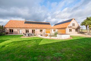 *** TE KOOP *** Rebecq - Bierghes - Charmante villa in boerderijstijl met 4 slaapkamers, een tuin en een ruime garage, ideaal gelegen in een rustige omgeving, met een totale oppervlakte van ongeveer 364 m². Op de begane grond is de indeling als volgt: een inkomhal, een volledig ingerichte open keuken (koelkast met vriesvak, oven, magnetron, afzuigkap, vaatwasser, keramische kookplaat en granieten werkblad) van ± 22 m², een ruime woonkamer van ± 47 m² met open haard (Brisach), een master suite van ± 22 m² met een eigen badkamer (hoekbad met hydromassage, inloopdouche, wastafelmeubel &amp; toilet), een wasruimte van ± 18 m²  en een apart toilet. Op de verdieping: via een eerste overloop, een slaapkamer van ± 26 m² met eigen badkamer. Via een tweede nachthal, twee slaapkamers van ± 15 en 14 m², elk met een eigen badkamer, een ruime multifunctionele ruimte van ± 47 m² en een apart toilet.<br /><br />Comfort: EPC “C” (197 kWh/m²/jaar). Grote garage van ± 100 m² met een gemotoriseerde sectionaaldeur, evenals 6 parkeerplaatsen buiten. Achterterrein met een mooie omheinde tuin, ideaal gelegen op het zuidoosten. Terras van ± 38 m², aangevuld met een tuinhuisje, een serre en een gezellige vijver. Houten kozijnen met dubbele beglazing. Verwarming met omkeerbare warmtepomp + stookolie. Installatie van 24 zonnepanelen. Elektrische poort met videofoon. Aanwezigheid van een zuiveringsinstallatie van 10.000 L.<br /><br />Prijs: V.O. vanaf 675.000 euro (onder voorbehoud van goedkeuring door de eigenaar)<br /><br />Contact: tubize@weinvest.be of tel. 02.355.42.20 of Julie op 0472.53.66.84