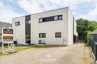 Voor meer info en foto’s, surf naar www.swevers.be – deze recente halfopen bebouwing in de Stationsstraat 85 D in Houthalen-Helchteren combineert ruimte, comfort en energiezuinig wonen op een uitstekende locatie. De woning werd gebouwd in 2019, is volledig instapklaar en afgewerkt met kwalitatieve, neutrale materialen. Met een bewoonbare oppervlakte van 203 m² op een zuidgericht perceel van 1.266 m² geniet u hier van veel licht, een praktische indeling en een aangenaam gevoel van rust. Vergis u niet, de tuin loopt volledig door tot achteren waardoor u op uw eigen perceel volop van de natuur kan genieten of de kinderen in alle vrijheid kunnen ravotten. Op het gelijkvloers komt u binnen via de inkomhal met gastentoilet. Verder vindt u een ruime wasplaats, een ruime bureauruimte die ook kan dienen als gelijkvloerse slaapkamer, en een lichtrijke leefruimte van ongeveer 40 m² met zicht op terras en tuin. De open keuken van 14 m² is volledig uitgerust met hoogwaardige toestellen, waaronder een stoomoven, heteluchtoven, koffieapparaat, vaatwasser en inductiekookplaat. Aansluitend zijn er nog een berging en een extra hal met ingemaakte kasten. De verdieping telt nog vier volwaardige slaapkamers van 14 m², 12 m², 10,60 m² en 10,60 m², een extra bergruimte, een badkamer met douche en dubbele lavabo, en een apart toilet. Dankzij de vele praktische bergruimtes is elke vierkante meter optimaal benut. Buiten geniet u van een ruime, zuidgerichte tuin met blijvend groen verzicht achteraan door het aangrenzende agrarische gebied. Extra troeven zijn vloerverwarming, zonnepanelen, warmtepomp, domotica, videofoon, screens aan de achterzijde en een elektrische poort. Winkels, scholen, openbaar vervoer en snelwegen bevinden zich vlakbij. Voor meer informatie, bel 011 255 155. Bron bewoonbare oppervlakte: EPC – verslag.