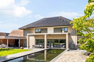 TE KOOP: Ruime en energiezuinige villa met zwemvijver in Sint-Eloois-Winkel!<br /><br />Deze instapklare en uitstekend onderhouden woning is gelegen in Sint-Eloois-Winkel, op een centrale locatie met vlotte bereikbaarheid en nabij alle voorzieningen.<br /><br />De woning, gebouwd in 2011, bevindt zich op een ruim perceel van 1.688 m² en beschikt over een bewoonbare oppervlakte van ca. 393 m². Dankzij de doordachte indeling, kwalitatieve afwerking en talrijke troeven biedt deze eigendom alle comfort voor wie op zoek is naar ruim en aangenaam wonen.<br /><br />INDELING:<br />Op het gelijkvloers bevinden zich een ruime leefruimte (met bar), volledig uitgeruste leefkeuken van 26 m², bureauruimte, praktische was-/bergruimte met douche en garage met sectionale poort. Op de verdieping zijn er vier slaapkamers en een badkamer aanwezig (vrijstaand ligbad en inloopdouche). Daarnaast beschikt de woning over een ruime zolder van ca. 50 m², die reeds is ingericht als vijfde slaapkamer.<br /><br />Buiten geniet u van een prachtig aangelegde (2014) zuidgerichte tuin van ca. 800 m² met ruim terras van 60 m², verwarmde zwemvijver met warmtepomp, overdekte buitenbar en tuinberging — ideaal voor ontspanning en gezellige momenten met familie en vrienden.<br /><br />Deze eigendom is ideaal voor gezinnen of wie op zoek is naar een ruime, energiezuinige woning met hoogwaardige afwerking en uitstekende buitenbeleving.<br /><br />Wat maakt deze eigendom uniek?<br />♦ bewoonbare oppervlakte van ca. 393 m²<br />♦ ruim perceel van 1.688 m²<br />♦ vijf volwaardige slaapkamers<br />♦ bureauruimte ideaal voor thuiswerk<br />♦ zuidgerichte tuin met verwarmde zwemvijver<br />♦ ruim terras en overdekte buitenbar<br />♦ vloerverwarming en dubbele beglazing<br />♦ energiezuinige woning (zonnepanelen)<br />♦ achteraan het perceel mag nog een bijgebouw geplaatst worden (wachtbuizen liggen klaar)<br />♦ regenwater aangesloten (2 x 10.000 liter)<br /><br />Interesse in deze ruime gezinswoning met tal van troeven?<br />Contacteer ons vandaag nog: charlotte@immobeguin.be