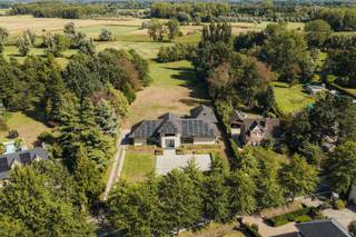 <strong>Imposante villa (BJ 2015) met onder meer vijf slaapkamers, twee badkamers, een buitenzwembad en een sfeervol ingericht bijgebouw met sauna, gelegen in Laarne.</strong><br /><br />Deze ruime villa (ca. 380 m²) met een hoge afwerkingsgraad is gelegen nabij het centrum van Laarne. Winkels en dagelijkse voorzieningen bevinden zich in de nabije omgeving, terwijl de vlotte verbinding met de R4 en E17 zorgt voor een uitstekende bereikbaarheid.<br /><br />De woning bevindt zich op een royaal terrein van circa 6.650 m², waar de groene omgeving zorgt voor een uitgesproken gevoel van ruimte en privacy. Aan de voorzijde van de villa is ruime parkeergelegenheid voor zes wagens voorzien.<br /><br />Met vijf slaapkamers en twee badkamers, waaronder de hoofdslaapkamer met doorloopdressing en en-suitebadkamer op het gelijkvloers, biedt de woning bijzonder veel ruimte en comfort. De royale leefruimtes, met onder meer een ruime keuken met kookeiland, Miele-toestellen, La Cornu gasfornuis en wijnfrigo, sluiten dankzij de grote raampartijen mooi aan op de buitenomgeving. Dit alles maakt van de woning een bijzonder aangename en volwaardige gezinswoning.<br /><br />Ook op het vlak van wooncomfort is deze recente villa met EPC A-label toekomstgericht uitgerust, met onder meer een warmtepomp, vloerverwarming, externe zonnewering en maar liefst 48 zonnepanelen.<br /><br />Het vrijstaande bijgebouw werd ingericht als volwaardige wellnessruimte met sauna, douche en gashaard. Op de verdieping bevindt zich een rust- of slaapgedeelte, waardoor het geheel zich eveneens uitstekend leent als gastenverblijf. Aansluitend aan het terras bevindt zich een ruim buitenzwembad, aangevuld met een buitendouche en jacuzzi.<br /><br /><strong>Kortom, een luxueuze en instapklare villa (BJ 2015) op een uitzonderlijk ruim terrein, met buitenzwembad en een veelzijdig bijgebouw.</strong>