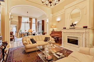 <p>The apartment is accessed via a welcoming entrance hall with built-in wardrobes. This leads to the living room, which immediately sets the tone with its beautiful archway, marble fireplace, mouldings, high ceilings, large windows and original herringbone parquet flooring,… this apartment is full of authentic features and enjoys an extremely stylish and classic appearance.</p>
<p>There is also a second lounge that can perfectly serve as a bedroom, office or hobby room.</p>
<p>The kitchen is equipped with a double sink, dishwasher, induction hob, extractor hood, eye-level oven and refrigerator. The utility room provides a practical space for a washing machine and dryer.</p>
<p>Furthermore, there is a second bedroom with an en-suite bathroom fitted with a double washbasin, walk-in shower and built-in wardrobes. The toilet is separate.</p>
<p>As the cherry on top, there is a particularly cosy terrace where you can relax and enjoy the peace and quiet.</p>
<p>Monthly charges: €275.00 (including water and heating).</p>
<p>Technical details: cellar with wine cabinet and built-in cupboards, insulated roof, wooden double glazing, security door, (fire) alarm system, videophone,…</p>
<p>The property is not located in a flood-risk area (P-score and G-score: C).</p>