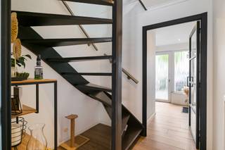 <p><span>Op een gunstige locatie te Hoevenen vinden we deze verzorgde bel-etage met vier slaapkamers en één badkamer. Gunstig energielabel (score: 122kWh/(m²jaar) - label: B) en elektriciteit conform!</span></p><p><span>Recente verwarmingsinstallatie, zonnepanelen, batterij én laadpaal! Volledig vernieuwde elektrische installatie! Deze woning is helemaal klaar voor de toekomst.</span></p><p><span>We betreden de woning via de inkomhal (met gastentoilet), welke ons toegang geeft tot de garage (met alle technische installaties en de voorzieningen voor wasmachine en droogkast) en de (trap)hal. Absolute troef is hier echter de bijzonder ruime polyvalente kamer achteraan de woning. De ruimte met haar grote raampartijen (richting de tuin) maakt deze ruimte ideaal als bureau, praktijkruimte, hobbykamer, speelkamer en/of slaapkamer. Deze polyvalante ruimte zou ook kunnen worden omgevormd tot een zogenaamde zorgwoning! De ruimte is hier zeker voor aanwezig.</span></p><p><span>De eerste verdieping vormt het hart van de woning. De ruime en lichtrijke leefruimte biedt plaats aan een comfortabele zit- en eethoek en sluit mooi aan op de stijlvolle open keuken. Deze hedendaagse keuken met kookeiland en koffiecorner is voorzien van voldoende kast- en werkbladruimte en verder als volgt uitgerust: kookplaat (inductie) met ingebouwde afzuiging, spoelbak, vaatwasser, oven, microgolfoven en koelkast. Vanuit de keuken bereikt men het ruime, volledige vernieuwde terras, alwaar het heerlijk vertoeven is met zicht over de tuin.</span></p><p><span>Op de tweede verdieping geeft de nachthal toegang tot drie volwaardige slaapkamers en de verzorgde badkamer met ligbad (met douchevoorziening), toilet en badkamermeubel (dubbele wastafel). De ruime master beschikt bovendien ook over een praktische dressing met heel wat bergruimte.</span></p><p><span>Aan buitenruimte geen gebrek! Naast het terras op de eerste verdieping vinden we op het gelijkvloers een onderhoudsvriendelijk aangelegde tuin met een terras en een tuinhuis met overkapping. Dit laatste is een uiterst gezellige plek, alwaar men gedurende de meeste seizoenen van de tuin kan genieten.</span></p><p><span>Ook voldoende parkeergelegenheid op eigen terrein! Met een garage (met geautomatiseerde sectionaal poort) en twee parkeerplaatsen voor de woning is er hieraan geen gebrek!</span></p><p><span>Een instapklare en energiezuinige gezinswoning met verrassend veel ruimte, een moderne keuken, vier slaapkamers, garage én heerlijke buitenruimtes! De fantastische buren krijg je er zomaar bij!</span></p>