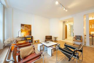 Consultez à l’avance la visite vidéo, le plan et les informations sur le site de Wellimmo (documents).<br /><br />Appartement entièrement rénové d’une chambre — calme, chaleur et raffinement<br />Dans cet appartement entièrement rénové d’une chambre, calme, chaleur et raffinement se fondent en un ensemble harmonieux. L’intérieur respire le design et la sérénité, avec un mélange soigneusement équilibré de matériaux naturels tels que le microciment, le noyer, le liège et le parquet authentique. Des teintes neutres douces et des détails réfléchis confèrent un aspect intemporel et élégant. La cohérence des formes et le subtil jeu des textures donnent à l’appartement une allure presque « galerie d’art », à la fois minimaliste et chaleureux, parfaitement vivable.<br /><br /><u>Disposition &amp; finitions</u><br />- Cuisine entièrement sur mesure en bois de noyer (HPL) avec plan de travail en composite Louis Culot<br />- Appareils intégrés Bosch et solutions de rangement optimisées<br />- Transition fluide entre cuisine et espace de vie, pour une ambiance chaleureuse et élégante<br />- Banquette intégrée en microciment, créant un coin repas intime et convivial<br />- Sols en microciment dans la cuisine, l’espace repas, la salle de bain et la terrasse pour un rendu harmonieux<br />- Parquet authentique en chevron, restauré avec soin<br />- Murs en liège dans l’espace repas et la chambre, apportant texture naturelle et confort acoustique<br />- Interrupteurs en laiton de la marque belge CJC et éclairage LED  pour une ambiance subtile<br />- Commande intelligente via l’application SmartLife + « bouton tout éteindre » à la sortie<br />- Toilettes séparées avec porte pivotante moderne pleine hauteur<br />- Mobilier entièrement sur mesure inclus — prêt à emménager et finition impeccable<br />- Terrasse avec sol en microciment, visuellement connectée à l’espace intérieur et conçue comme un havre de paix<br />- Cave privative et local à vélos disponibles <br /><br /><u>Un refuge en ville</u><br />Cet appartement incarne une cohérence architecturale pure et un luxe discret. Chaque détail est pensé pour offrir repos, respiration et plaisir. Un intérieur intemporel qui ne se contente pas de faire impression, mais qui donne véritablement l’impression de rentrer chez soi.