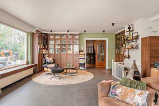 <p><strong>Unieke woning met 4 à 5 slaapkamers <br /></strong></p>
<p>Op een rustige en groene locatie bevindt zich deze <strong>ruime, gedeeltelijk gerenoveerde woning</strong> met bijzonder veel potentieel. Dankzij de aanwezigheid van<strong> vier a vijf slaapkamers</strong>, <strong>twee keukens</strong> en <strong>twee leefruimtes</strong> biedt dit pand een unieke opportuniteit voor grote gezinnen, samengestelde gezinnen of wie op zoek is naar een woning met <strong>cohousing- of kangoeroemogelijkheden</strong>.</p>
<p>De woning combineert ruimte en flexibiliteit met een solide basis, waarbij reeds een deel werd gerenoveerd. Verdere afwerking kan volledig naar eigen smaak gebeuren (slaapkamers moeten nog verder afgewerkt worden), waardoor dit een ideale investering is voor wie een thuis wil creëren op maat.</p>
<p><strong>Indeling</strong></p>
<p><strong>Gelijkvloers<br /></strong>- Ruime inkomhal met apart gastentoilet<br />- Ruime living met grote raampartijen en ingemaakte kasten. Elektrische haard met warmtefunctie aanwezig<br />- Eetkamer met schuifraam naar het terras<br />- Open, volledig uitgeruste keuken met koelkast, diepvries, oven, microgolfoven, vaatwasser, inductiekookplaat en dampkap. Ook hier is een schuifraam aanwezig.</p>
<p><strong>Halve verdieping naar boven<br /></strong>- Multifunctionele kamer, geschikt als bureau of extra slaapkamer<br />- Eerste slaapkamer ( af te werken) met terras aan de voorzijde<br />- Tweede ruime slaapkamer<br />- Recent gerenoveerde badkamer (± 4 jaar) met inloopdouche, toilet, dubbele lavabo</p>
<p><strong>Benedenverdieping<br /></strong>- Leefruimte met parketvloer<br />- Tweede keuken (± 2011) uitgerust met combi-oven, inductiekookplaat en dampkap<br />- Badkamer met toilet, douchecabine en lavabo<br />- Aansluitende slaapkamer met ingemaakte kasten<br />- Automatische rolluiken aan de voorzijde</p>
<p><strong>Praktische ruimtes<br /></strong>- Wasruimte met aansluiting voor twee wasmachines en één droogkast<br />- Extra opbergruimte<br />- Volledig onderkelderd (hoogte ± 1,70 m)<br />- Zolder bereikbaar via vlizotrap</p>
<p><strong>Tuin<br /></strong>- Volledig omheinde tuin van ca. 25 meter diep<br />- Terras<br />- Vijver met waterval<br />- Afbraak klaar tuinhuis<br />- Fietsenberging aan de zijkant<br />- Aangename buitenruimte met veel rust en privacy</p>
<p><strong>Troeven<br /></strong>- Zeer ruime woning met flexibele indeling<br />- 4 a 5 slaapkamers, 2 keukens en 2 leefruimtes, ideaal voor kangoeroewonen, cohousing of meergeneratiewonen<br />- Gedeeltelijk gerenoveerd met verdere afwerkingsmogelijkheden<br />- Elektrische haard en veel natuurlijke lichtinval<br />- Volledig onderkelderd<br />- Ruime parkeermogelijkheden (2 tot 4 wagens)<br />- Rustige, groene ligging<br />- Schuiframen voorzien van horren<br />- Dak volledig genrenoveerd 2024<br />- keuken en badkamer gerenoveerd 2021-2022</p>
<p><strong></strong><strong>Blijf onze website in het oog houden voor meer foto's</strong></p>
<p></p>