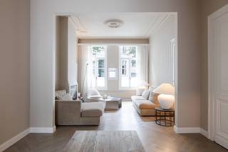 <p>On Van Noortstraat, a charming 19th-century street near the City Park, stands this townhouse, fully renovated in 2025. Laid out in 1870, the street is renowned for its beautifully preserved neoclassical townhouses. This property, with its stately white-rendered façade and tall windows, is a fine example. Behind its historic frontage lies a home that has been meticulously renovated, seamlessly combining authentic character with contemporary comfort.</p>
<p>The house unfolds around a light-filled living space extending throughout the ground floor. During the renovation, the original ornamental ceilings were carefully preserved. The herringbone parquet flooring, which runs throughout the entire house, lends every room a timeless elegance.</p>
<p>The sitting room, featuring a cosy gas fireplace, flows effortlessly into the dining area beneath a glass skylight. The adjoining SIEMATIC kitchen combines sleek contemporary design with warm, natural materials. Marble worktops and splashbacks, integrated Miele appliances, a PITTCOOKING gas hob and a Quooker tap on the central island create a refined space for cooking and gathering — the true heart of the home.</p>
<p>Large French doors open onto a charming city garden, offering a private outdoor retreat to enjoy long summer evenings.</p>
<p>An authentic staircase leads to the upper floors. The mezzanine level has been arranged as a comfortable bathroom with a double washbasin, shower and toilet.</p>
<p>The entire first floor is dedicated to a spacious master suite. Finished in the same marble as the kitchen, including matching skirting boards, and complemented by a separate guest toilet, this floor exudes understated luxury. The bedroom impresses with its high ceilings, original decorative plasterwork and elegant fireplace. An adjoining dressing room, finished in marble and fitted with bespoke storage, completes this refined private retreat.</p>
<p>The second floor features a generous second bedroom with its own en-suite bathroom, again finished with marble and herringbone flooring, ensuring a harmonious and sophisticated aesthetic throughout.</p>
<p>The third floor offers two additional bedrooms. Original exposed wooden beams highlight the home's authentic character. One of the bedrooms also features a charming mezzanine level, accessible via its own staircase, creating a unique sense of space and character.</p>
<p>The exceptional quality of the finishes is evident throughout the entire property. Air conditioning in every bedroom ensures optimal comfort during the warmer months. The house also benefits from a full basement, providing ample storage space, as well as housing the technical installations and water pressure pump. Additional features include a camera security system and a digital video intercom.</p>
<p>A parking space in a nearby car park is available for purchase at an additional price of <strong>EUR 35,000</strong>.</p>