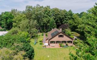 <p><span>Gelegen in het glooiende landschap van het pittoreske Tielrode treft u dit unieke perceel. Via de oprijlaan bereikt u de woning, die centraal op het perceel is ingeplant. Dankzij het niveauverschil ligt de woning hoger ten opzichte van het straatniveau, wat zorgt voor optimale privacy en een aangenaam uitzicht.</span></p><p><span> </span></p><p><span>De belangrijkste troeven in een notendop:</span></p><ul><li><span>Groot perceel van 3.291 m²</span></li><li><span>Pittoresk gelegen in Tielrode, nabij de Durmevallei en de Roomakker</span></li><li><span>Piekfijn onderhouden woning met tal van mogelijkheden</span></li><li><span>Recent voorzien van zonnepanelen</span></li><li><span>Prachtig aangelegde tuin met bos</span></li><li><span>4 slaapkamers en 2 badkamers</span></li></ul><p><span> </span></p><p><span>U betreedt de woning via de inkomhal met gastentoilet. Van hieruit heeft u toegang tot het leefgedeelte, bestaande uit een ruime leefruimte op parket met gezellige zitput, een aparte keuken, berging en bureauruimte.</span></p><p><span>Het nachtgedeelte omvat vier slaapkamers en twee badkamers.</span></p><p><span> </span></p><p><span>Via een vaste trap bereikt u de eerste verdieping, die momenteel is ingericht als zolderruimte met een extra kamer. Daarnaast beschikt de woning over een kruipkelder en twee carports.</span></p><p><span> </span></p><p><span>Door de centrale ligging van de woning op het perceel ontstaat een aangename binnen-buitenbeleving en woont u letterlijk midden in het groen. De volwassen bomen, de fraai aangelegde tuin en het omliggende bos zorgen voor een uitzonderlijk gevoel van rust en privacy.</span></p><p><span> </span></p><p><span>Wenst u deze bijzondere woning zelf te ontdekken? Contacteer Axel Lenaerts makelaars voor een bezoek.</span></p><p><span>Richtprijs: € 699.000</span></p><p><span> </span></p>