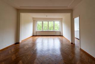 Op een topligging in de Harmoniewijk bevindt zich dit karaktervolle en lichtrijke appartement van ca. 80 m², gelegen op de zesde verdieping van een rustige en kleinschalige residentie. Dankzij de hoogte geniet u van veel licht, rust en een open groen uitzicht op de Harmonie en het Koning Albertpark, zonder inkijk.<br /><br />INDELING<br />Via de lift bereikt u het appartement op de zesde verdieping. De inkomhal is afsluitbaar en beschikt over een ingebouwde vestiaire en een apart gastentoilet. Vanuit de inkomhal komt u in de ruime woon- en eetruimte met authentieke post-interbellumdetails en een mooie visgraatparket, wat meteen voor charme en karakter zorgt.<br /><br />De gesloten keuken is recent vernieuwd en uitgerust met ingebouwde toestellen: gaskookplaat, dampkap en vaatwasser (nieuw) en oven met plaats voor eigen koelkast en wasmachine. Net als de leefruimte is er ook in de keuken zeer veel lichtinval.<br /><br />Het appartement beschikt over één ruime slaapkamer, gelegen aan de rustige achterzijde van het gebouw, met ingebouwde kasten tot plafondhoogte en een rechtstreekse toegang tot het terras. De badkamer en suite is voorzien van een bad en lavabo. Het gezellige terras aan de achterzijde biedt een aangename buitenruimte met ochtendzon.<br /><br />TROEVEN<br />- Zesde verdieping: veel licht, vrij uitzicht en privacy<br />- Groen uitzicht op de Harmonie en het Albertpark<br />- Authentiek parket en karaktervolle afwerking<br />- Recent vernieuwde keuken met ingebouwde toestellen<br />- Terras aan de rustige achterzijde (met zicht op de tuin)<br />- Onmiddellijk beschikbaar<br />- Parkeermogelijkheid op straat<br />- Centrale ligging binnen de Singel<br />- Vlotte verbinding met openbaar vervoer en belangrijke invalswegen (E19, A12, E17)<br />- Op wandelafstand van parken, winkels, horeca en brouwerij De Koninck<br /><br />PRAKTISCHE INFORMATIE<br />- Maandelijkse provisie kosten: 150 euro incl. water en verwarming via tussenmeters<br />- Voor eigen kosten: Elektriciteit, gas en internet-fiber aansluiting<br />- Gunstige EPC score van 185 kWh/m²