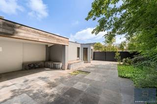 <p>Bent u op zoek naar een woning waar <span>wonen en werken</span> perfect gecombineerd kunnen worden? Of droomt u van een <span>kangoeroewoning</span> of een <span>ruime gezinswoning met tal van mogelijkheden</span>? Dan is deze uitzonderlijk ruime woning (438 m²) in het centrum van Maldegem precies wat u zoekt.</p>
<p>De woning geniet van een centrale ligging met alle voorzieningen op wandelafstand: winkels, scholen en openbaar vervoer bevinden zich in de onmiddellijke omgeving. Bovendien is er een vlotte verbinding naar zowel de kust als het binnenland.</p>
<p>Bij het betreden van het pand vallen meteen de twee afzonderlijke ingangen op: één naar de voormalige tandartsenpraktijk en één naar de privéwoning, met onderlinge doorgang tussen beide units.</p>
<p><strong>Via de eerste ingang</strong> bereikt u de praktijkruimte, bestaande uit een inkomhal met gastentoilet, een aparte berging, wachtruimte, bureauruimte en twee voormalige kabinetten. Deze ruimtes zijn uitgerust met airconditioning en lenen zich perfect voor een vrij beroep of kunnen ingericht worden als een volwaardige tweede woonunit.</p>
<p><strong>De tweede ingang</strong> leidt naar de ruime privéwoning. U komt binnen in een royale inkomhal met ingemaakte vestiairekasten en gastentoilet. De lichtrijke leefruimte omvat een gezellige eetplaats en woonkamer met open haard. Aansluitend bevindt zich de open keuken met extra eetruimte. Deze hoogwaardige Siematic-keuken is uitgerust met een natuurstenen werkblad, Amerikaanse koelkast met vriezer, gas- en inductiekookzones, Venduro dampkap, Miele inbouwfriteuse, extra brede oven, combi-oven en dubbele spoelbak. Verder is er een unieke inloopkoelcel voorzien in de hal, evenals een praktische wasplaats met ingemaakte kasten en extra bergruimte.</p>
<p>Op de <span>eerste verdieping</span> bevinden zich vijf volwaardige slaapkamers en twee badkamers, elk uitgerust met lavabo en douche. De <span>tweede verdieping</span> herbergt een prachtige master bedroom met ensuite badkamer voorzien van lavabo, bubbelbad, douche en toilet. Ook hier is airconditioning aanwezig voor optimaal comfort.</p>
<p>Daarnaast beschikt de woning over een praktische <span>kelder</span>.</p>
<p>Buiten geniet u van een gezellig, <span>ingesloten terras</span> dat rechtstreeks toegankelijk is vanuit de keuken. Achteraan bevindt zich een <span>ruime tuin met een groot aangelegd terras</span>, deels overdekt en voorzien van een open haard – ideaal om het hele jaar door te genieten. Verder zijn er meerdere tuinbergingen met extra zolderruimte en vaste trap.</p>
<p>Vooraan is er een <span>oprit</span> met plaats voor twee wagens. Bovendien bestaat de mogelijkheid om naast de woning een garage te huren met ruimte voor drie wagens.</p>
<p>Kortom: <span><strong>een veelzijdige eigendom met tal van mogelijkheden op een toplocatie in Maldegem.</strong></span><br /><br />Benieuwd naar de mogelijkheden? <br /><span>Contacteer Bonne Vastgoed 7 op 7 via 050/73.73.73 of info@bonnevastgoed.be</span></p>