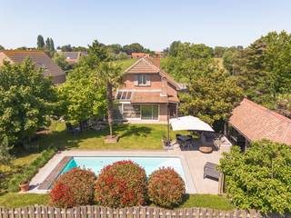 Kwalitatief gerenoveerde villa in tijdloze stijl op een residentiële locatie in Stabroek.<br /><br />We betreden de woning via de inkomhal, die is voorzien van een gastentoilet met handenwasser.<br /><br />De sfeervolle L-vormige leefruimte op kurkvloer, is ingedeeld in een gezellige zithoek met houtkachel en een eetkamer. Aansluitend werd een mooie veranda aangebouwd, die zorgt voor extra leefruimte en lichtinval.<br /><br />De gerenoveerde keuken in landelijke stijl is volledig uitgerust met een Boretti-kookfornuis met oven, een microgolf, spoelbak, vaatwasser en een koelkast.<br /><br />Op het gelijkvloers vinden we verder een slaapkamer en een vernieuwde badkamer, voorzien van een douche en een dubbele lavabo.<br /><br />Tot slot beschikt de woning op het gelijkvloers over een gerenoveerde garage met ingemaakte kasten en een praktische berging met aansluitingen voor wasmachine en droogkast.<br /><br />Op de eerste verdieping komen we uit op een ruime kantoorruimte, ideaal als thuiswerkplek of hobbyruimte. Vanuit het kantoor is er een prachtig zicht op de omliggende weilanden.<br /><br />De nachthal geeft toegang tot drie slaapkamers, waarvan één is voorzien van een sauna.<br /><br />De tweede badkamer beschikt over een inloopdouche en een enkele lavabo.<br /><br />Daarnaast bevinden zich op de nachthal nog een apart nachttoilet en een extra berging, wat zorgt voor extra comfort en extra opbergruimte.<br /><br />De rustgevende tuin heeft een gunstige oriëntatie op het zuidoosten en werd zorgvuldig aangelegd met mooie beplanting en een verwarmd zwembad (8 m x 4m) met automatische chloor- en pH-regeling. Voorts bevindt er zich nog een poolhouse.<br /><br />Vooraan bevindt zich een carport voor één wagen, er is tevens voldoende parkeerplaats op eigen grond.<br /><br />Algemeen:<br /><br />- Mogelijkheid tot gelijkvloers wonen.<br />- Luxevoorzieningen.<br />- EPC B.<br />- Elektriciteit conform.<br />- Residentiële locatie.<br /><br />Deze gezinswoning is gelegen in een rustige en residentiële buurt in Stabroek met enkel bestemmingsverkeer. Een zeer gegeerde locatie!<br />Alle voorzieningen zoals winkels, scholen en openbaar vervoer bevinden zich in de directe nabijheid.<br />De oprit van de autosnelweg is vlakbij met een goede verbinding naar Antwerpen, Nederland en de haven!
