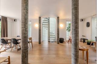<p><span>Architectural villa offering a unique living experience</span></p><p><span>Some homes are built to live in, others to experience. This exceptional architect-designed villa from 1993 undoubtedly belongs to the latter category.</span></p><p><span>Set on a 664 m² lot, this home offers 172 m² of living space, where space, light, and architecture complement each other perfectly. From the very first moment, the impressive living space catches your eye, where the generous ceiling height, large windows, and refined choice of materials create an exceptional atmosphere. The interior and exterior blend seamlessly thanks to the direct connection to the terrace and the lush garden.</span></p><p><span>At the heart of the home, the distinctive concrete spiral staircase serves as an architectural focal point, while the combination of exposed concrete, glass, and warm wooden floors creates a timeless aesthetic. The open living space also features a stylish, integrated work or reading nook—ideal for those who want to work comfortably from home without compromising the home’s open character.</span></p><p><span>The sleek, fully equipped kitchen complements the minimalist architecture perfectly and is designed with an eye for functionality and simplicity.</span></p><p><span>Upstairs, there are three bedrooms and a spacious bathroom with a bathtub and double sink.</span></p><p><span>The exterior of this home also exudes tranquility. The well-maintained garden forms a green oasis of privacy and features a charming pond that can easily be converted into a swimming pool if desired, allowing you to fully enjoy the outdoors.</span></p><p><span>With an EPC rating of C, a distinct architectural identity, and unique natural light, this villa is a rare opportunity for those seeking a home with character, quality, and a timeless appeal.</span></p><p><span>Highlights</span></p><ul><li><span>Architectural villa with a unique design</span></li><li><span>Living area: 172 m²</span></li><li><span>Lot size: 664 m²</span></li><li><span>3 bedrooms</span></li><li><span>Impressive living space with an integrated work area</span></li><li><span>Large windows and exceptional natural light</span></li><li><span>Modern, sleekly finished kitchen</span></li><li><span>Pond with the potential to be converted into a swimming pool</span></li><li><span>Built in 1993</span></li><li><span>EPC rating: C</span></li></ul><p><span><br /> </span></p>