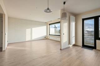 Aan de Sneeuwbeslaan 4 in Wilrijk ligt dit lichtrijke appartement op de <strong>vijfde verdieping </strong>van een appartementsgebouw met een sobere, tijdloze gevel. Het appartement heeft<strong> 2 slaapkamers</strong>, een<strong> terras</strong> en een <strong>ondergrondse autostaanplaats</strong>. Door de hoge ligging en de grote raampartijen langs meerdere zijden geniet je hier de hele dag van daglicht en van een vrij zicht over de tuinen, de hoge bomen en de skyline van de stad.<br /><br />De buurt<br />Het gebouw ligt in een groene omgeving in Wilrijk, met alles wat je dagelijks nodig hebt binnen handbereik. De <strong>supermarkt</strong> ligt naast het gebouw en in de straat zelf staat een Velo-station, zodat je met de deelfiets snel in het centrum van Antwerpen bent. De bushaltes van De Lijn, onder meer van <strong>lijn 17 en 33,</strong> liggen op wandelafstand. Met de wagen zit je in enkele minuten op de<strong> A12 en de E19.</strong><br />Opvallend in het straatbeeld is de witmarmeren<strong> Jaïntempel </strong>aan de Laarstraat. De tempel werd in India gebouwd uit blokken wit marmer, steen voor steen naar België verscheept en in Wilrijk opnieuw opgebouwd. Het is de grootste Jaïntempel buiten India. Vanop het <strong>terras </strong>heb je er een <strong>mooi zicht</strong> op.<br /><br />Dit appartement heeft een<strong> grondige facelift gekregen in 2018..<br /></strong><br />Indeling<br />Je komt binnen in een ruime inkomhal met sierlijsten aan het plafond, een ingebouwde vestiairekast, videofoon en een apart toilet. Van hieruit kijk je meteen door naar de leefruimte.<br />De leefruimte is ruim en licht. Ze heeft een lichte vloer in houtlook, inbouwspots en brede ramen langs twee zijden. De <strong>open keuken</strong> sluit hier naadloos op aan en is voorzien van alle <strong>hedendaagse comfort </strong>en veel werk- en bergruimte.<br />In het nachtgedeelte ligt de slaapkamer met een grote kastenwand, railverlichting en een raam met zicht op het groen. Een tweede kamer staat er via een open doorgang mee in verbinding. Ze is geschikt als tweede slaapkamer, als bureau of als ruime dressing. De<strong> badkamer</strong> is voorzien van een lavabomeubel, een toilet en een groot raam, wat zorgt voor veel natuurlijk licht. Enkele muren hebben nog behang, dat je eenvoudig naar eigen smaak kan aanpassen.<br /><br />Buiten<br />Zowel vanuit de leefruimte als vanuit de keuken stap je rechtstreeks het terras op. Aan de ene kant kijk je uit over de groene tuinen en hoge bomen, aan de andere kant over de daken van de buurt. Het is een fijne plek om buiten te eten of te genieten van de zonsondergang.<br />Het appartement beschikt over een <strong>ondergrondse autostaanplaats. Deze is verplicht aan te kopen aan €16.000.</strong><br /><br />Gebouw en kosten<br />Het gebouw beschikt over een lift. De gemeenschappelijke kosten bedragen ongeveer<strong> € 840 per kwartaal.</strong> Daarin zitten onder meer de <strong>verwarming</strong>, het<strong> water,</strong> de schoonmaak van de gemeenschappelijke delen, het afvalverzamelpunt, het onderhoud van de lift en de vergoeding van de syndicus.<br /><br />Troeven: 5de verdieping met vrij zicht over het groen, veel lichtinval langs twee zijden, open keuken met veel kastruimte, terras bereikbaar vanuit leefruimte en keuken, lift, ondergrondse autostaanplaats, <strong>Velo-station</strong> in de straat, supermarkt naast de deur.<br /><br /><strong>EPC: 143 kWh/m².jaar</strong><br /><br />Interesse? Contacteer ons voor een bezoek.
