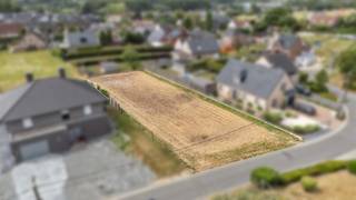 <p>Op een aangename en rustige ligging in Ophasselt bevindt zich deze mooie bouwgrond, <strong>lot 6 van een goedgekeurde verkaveling</strong>, bestemd voor het oprichten van een <strong>vrijstaande eengezinswoning</strong>. De ligging combineert rust met een goede bereikbaarheid. Winkels, openbaar vervoer en andere voorzieningen bevinden zich in de nabije omgeving, terwijl de verbindingswegen richting <strong>Geraardsbergen, Brakel en Ninove</strong> vlot bereikbaar zijn. Volgens de geldende verkavelingsvoorschriften is het perceel bestemd voor een vrijstaande eengezinswoning, waarbij de voorgevelbouwlijn op 5 meter achter de rooilijn ligt. De maximale bouwdiepte bedraagt 15 meter op het gelijkvloers en 12 meter op de verdieping. De bouwbreedte bedraagt 9.60 meter en de perceelbreedte +/- 15.60 meter. De kroonlijsthoogte dient tussen 3,40 meter en 6 meter te liggen en de woning wordt voorzien van een hellend dak met gelijkhellende dakvlakken en een dakhelling tussen 35° en 45°. Een garage kan worden geïntegreerd in het hoofdgebouw of, onder de voorwaarden van de verkavelingsvoorschriften, als afzonderlijke garage of bijgebouw worden opgericht met een maximale oppervlakte van 40 m². Een interessante bouwgrond voor wie op zoek is naar een <strong>ruime vrijstaande woning op een rustige locatie</strong>, met tegelijkertijd een vlotte strategische verbinding.</p>